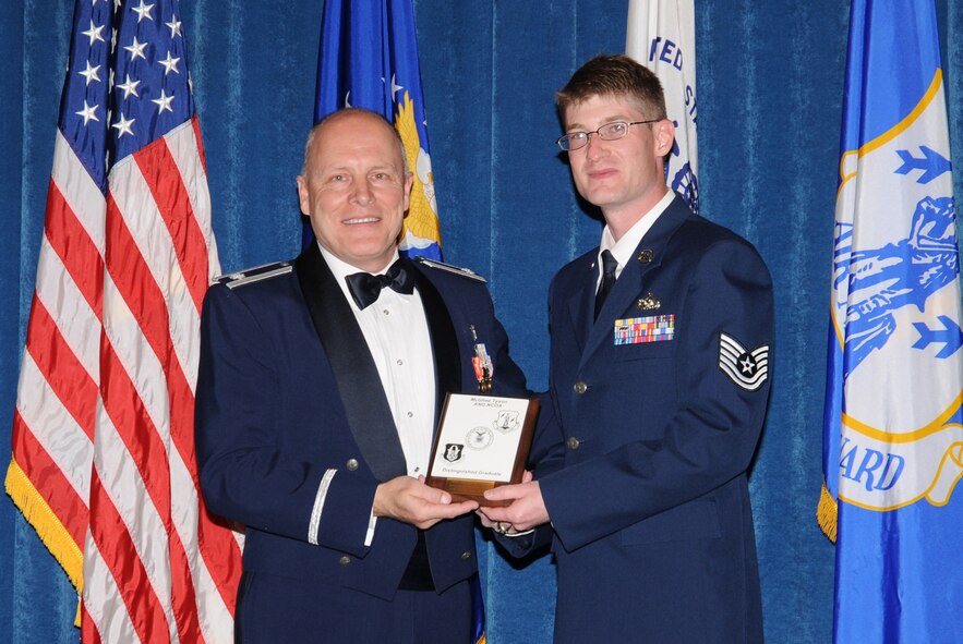 McGHEE TYSON AIR NATIONAL GUARD BASE, Tenn. -- Tech. Sgt. Kenneth D. Simpson, III, the assistant NCOIC, supply management with the 746th Test Support Squadron at Holloman AFB, N.M., receives the distinguished graduate award for NCO Academy Class 10-1 at The I.G. Brown Air National Guard Training and Education Center here from Lt. Col Stan Giles, Nov. 19, 2009.   The distinguished graduate award is presented to students in the top ten percent of the class.  It is based on objective and performance evaluations, demonstrated leadership, and performance as a team player.   (U.S. Air Force photo by Master Sgt. Kurt Skoglund/Released)