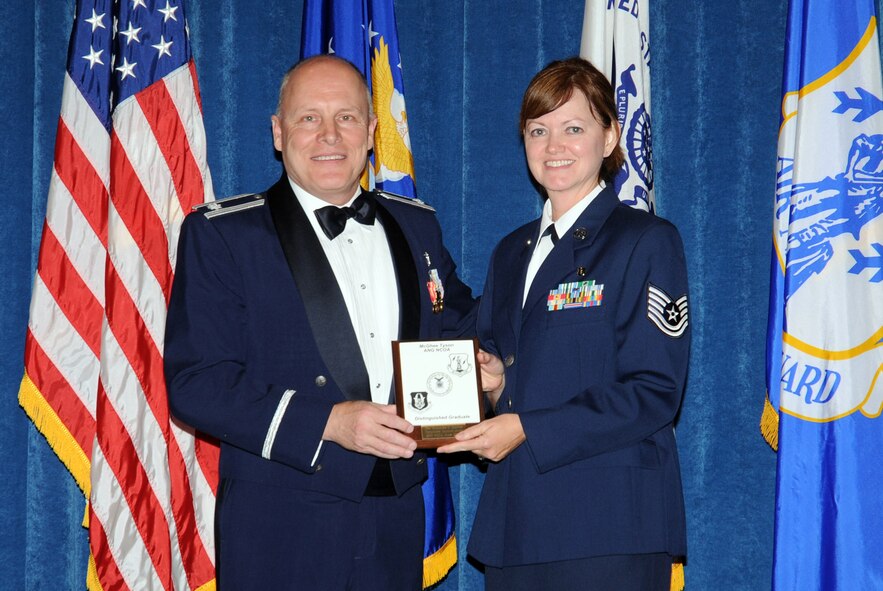 McGHEE TYSON AIR NATIONAL GUARD BASE, Tenn. -- Tech. Sgt. Shanamarie O. Harville, a medical services craftsman with the 134th Air Refueling Wing, Tennessee Air National Guard here, receives the distinguished graduate award for NCO Academy Class 10-1 at The I.G. Brown Air National Guard Training and Education Center here from Lt. Col Stan Giles, Nov. 19, 2009.   The distinguished graduate award is presented to students in the top ten percent of the class.  It is based on objective and performance evaluations, demonstrated leadership, and performance as a team player. (U.S. Air Force photo by Master Sgt. Kurt Skoglund/Released)