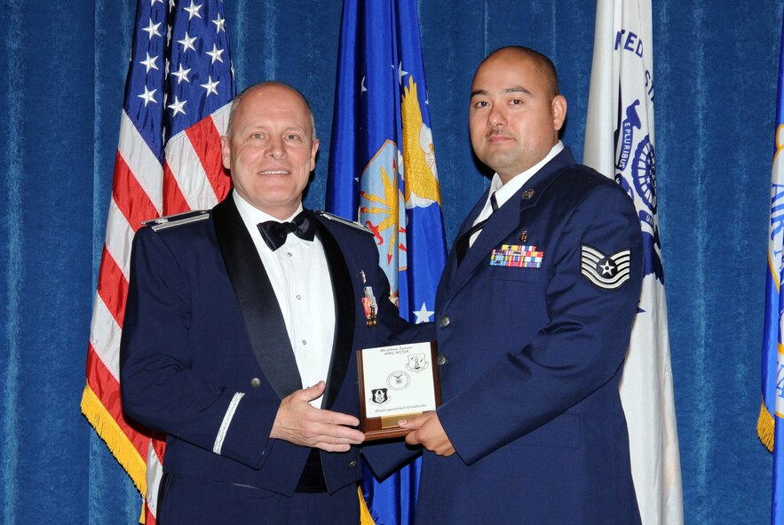 McGHEE TYSON AIR NATIONAL GUARD BASE, Tenn. -- Tech. Sgt. Joseph Guerrero, the NCOIC, bioenvironmental engineering at the 49th Fighter Wing, Holloman AFB, N.M., receives the distinguished graduate Award for NCO Academy Class 10-1 at The I.G. Brown Air National Guard Training and Education Center here from Lt. Col Stan Giles, Nov. 19, 2009.   The distinguished graduate award is presented to students in the top ten percent of the class.  It is based on objective and performance evaluations, demonstrated leadership, and performance as a team player.   (U.S. Air Force photo by Master Sgt. Kurt Skoglund/Released)