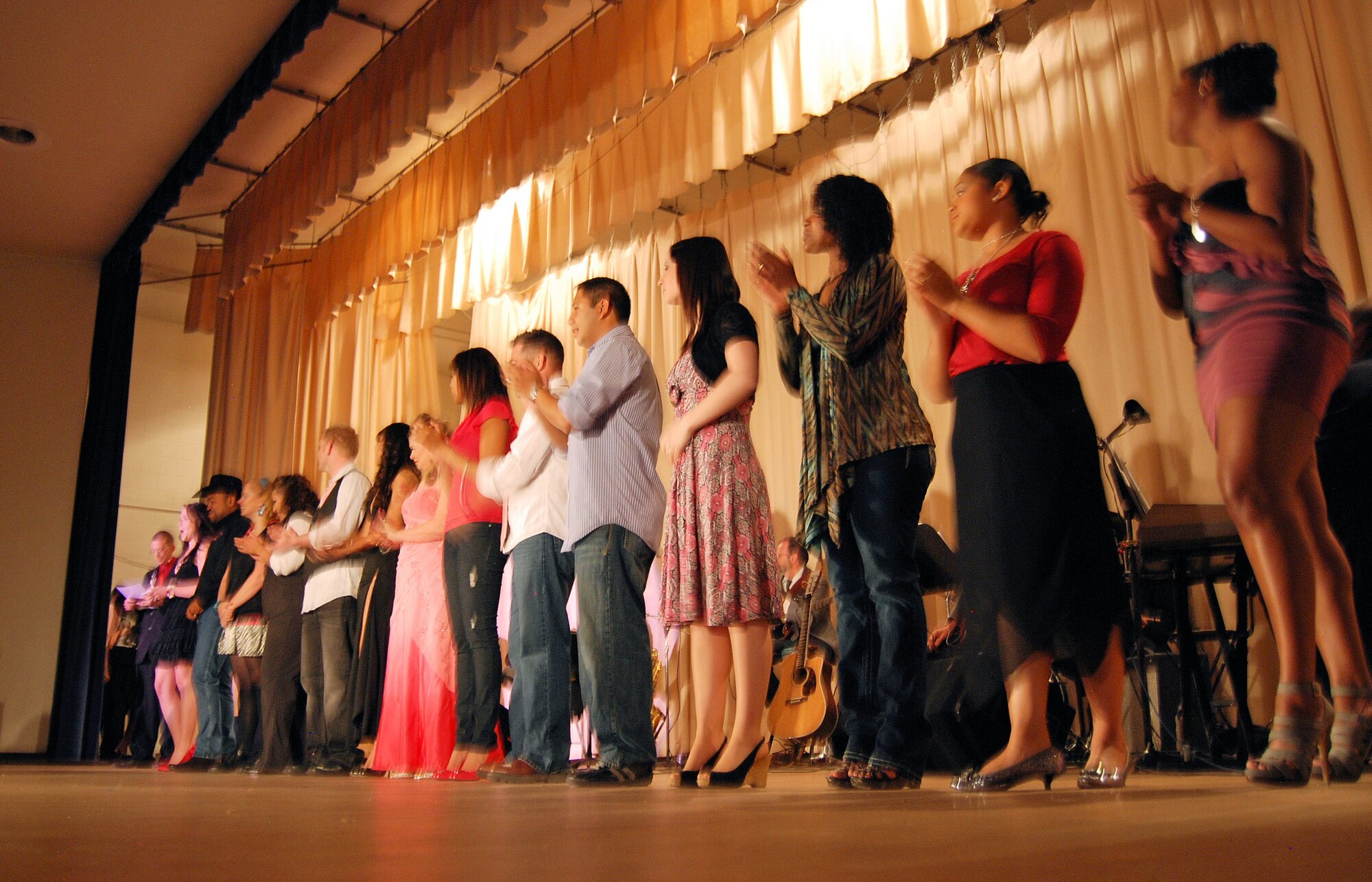 Singers from Peterson, Schriever, and the United States Air Force Academy return to the stage after entertaining audience members who attended the Frontrange Stars 2009 singing competition at the Base Auditorium Nov. 20. Performers competed for first, second, and third place as well as audience favorite in an annual competition that brings together both local military and civilian talent from across Colorado Springs. (Photo by Airman 1st Class Jessica Hines)