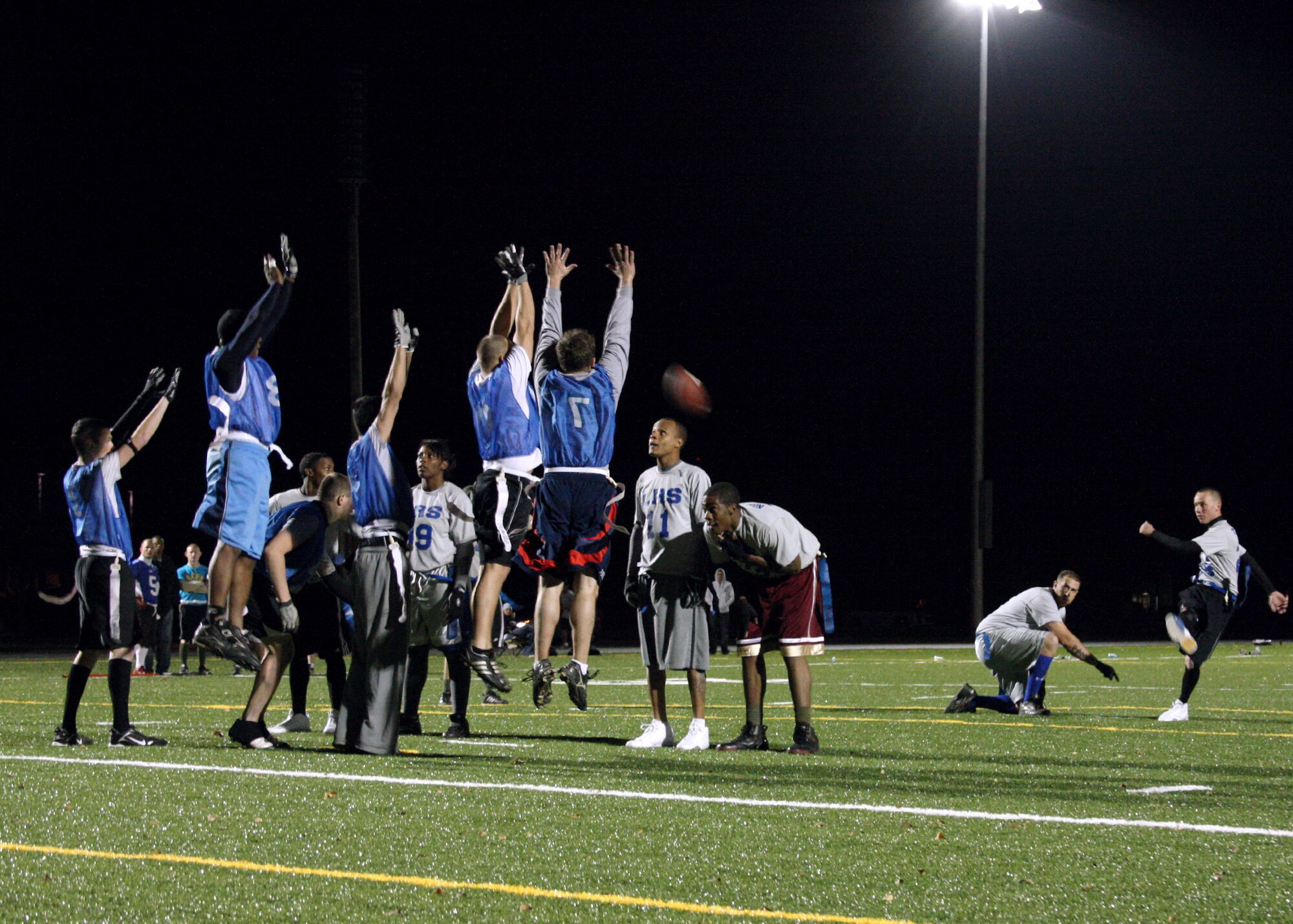 CANNON AIR FORCE BASE, N.M. -- The 27th Special Operations Logistics Readiness Squadron attempts an extra point en route to a 25-21 victory over the 27th Special Operations Equipment Maintenance Squadron Nov. 11 in one of the first games played on Cannon's new field. The field cost $1.4 million and replaced the "dust bowl" with artificial turf. (U.S. Air Force photo by Airman 1st Class Jette Warnick)