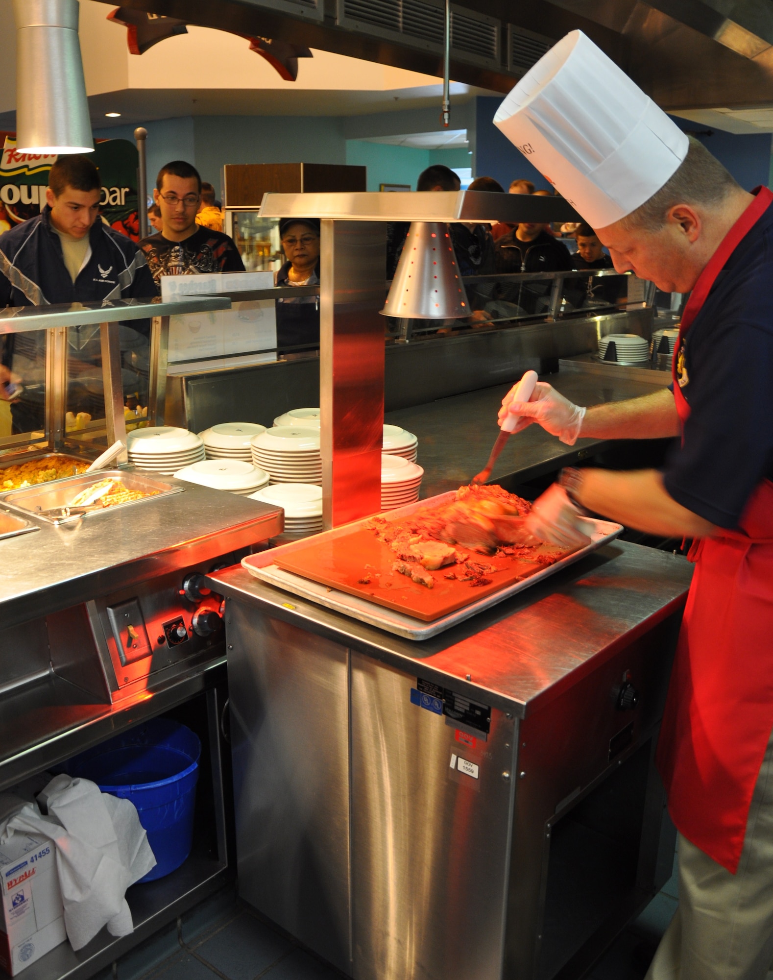 Chief Master Sgt. Kenneth Sallinger, 82nd Training Wing command chief, serves Thanksgiving meals to the Sheppard Airmen Nov. 26. Several officers and senior enlisted members manned the food stations at the Tumbleweed Dining Facility in this year’s event. (U.S. Air Force Photo/ Airman 1st Class Adawn Kelsey)