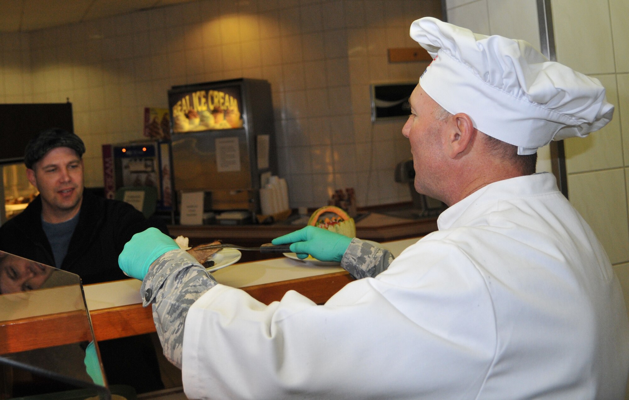 SPANGDAHLEM AIR BASE, Germany -- Col. Tip Wight, 52nd Fighter Wing commander, gives a slice of beef to Senior Master Sgt. Earle Babb, 52nd Aircraft Maintenance Squadron, Nov. 26. Members of the 52nd FW leadership and several other volunteers hosted this year's Thanksgiving meal at the Mosel Dining Facility. (U.S. Air Force photo/Airman 1st Class Nick Wilson)