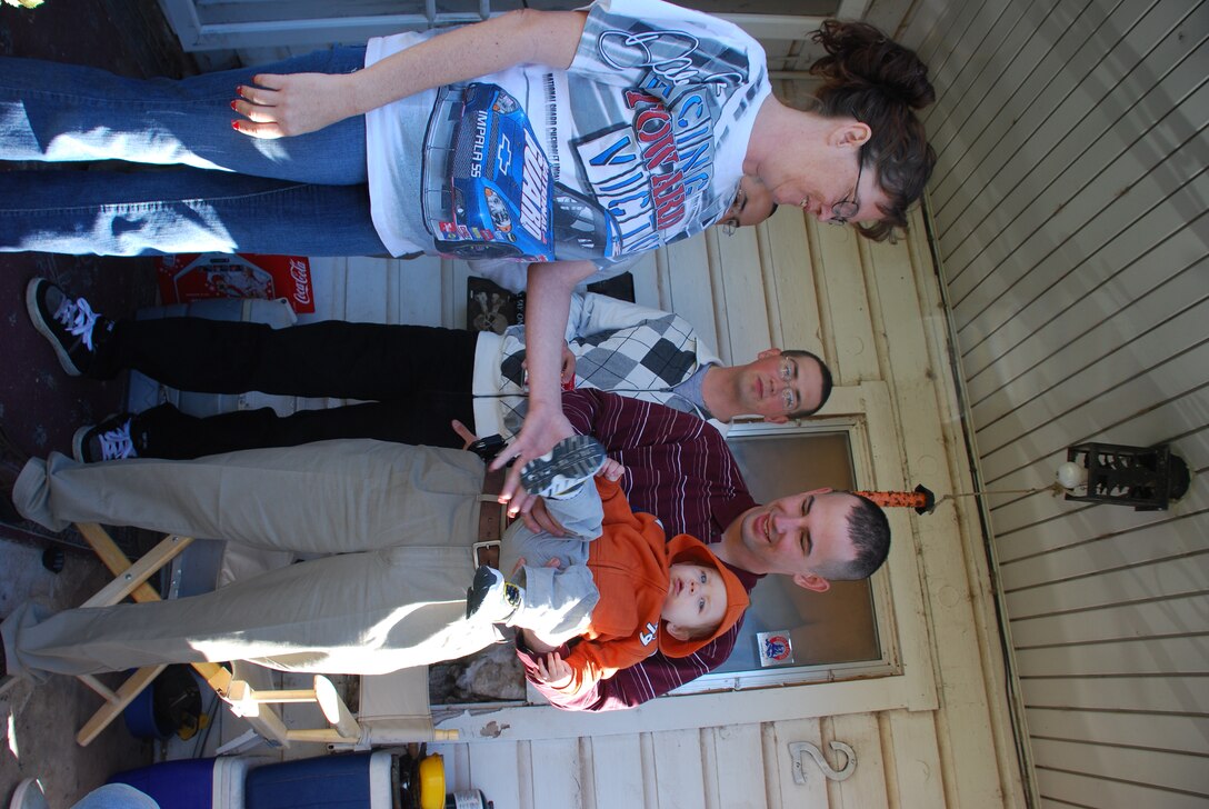 Airman 1st Class Jeff Brice (right), 361st Training Squadron, holds 10 month-old  Zachary Watts, while talking with Loretta Mullin (left), an Operation Thanksgiving host, and Airman Alvis Steven, 364th TRS. (U.S. Air Force photo/ Airman 1st Class Valerie Hosea)