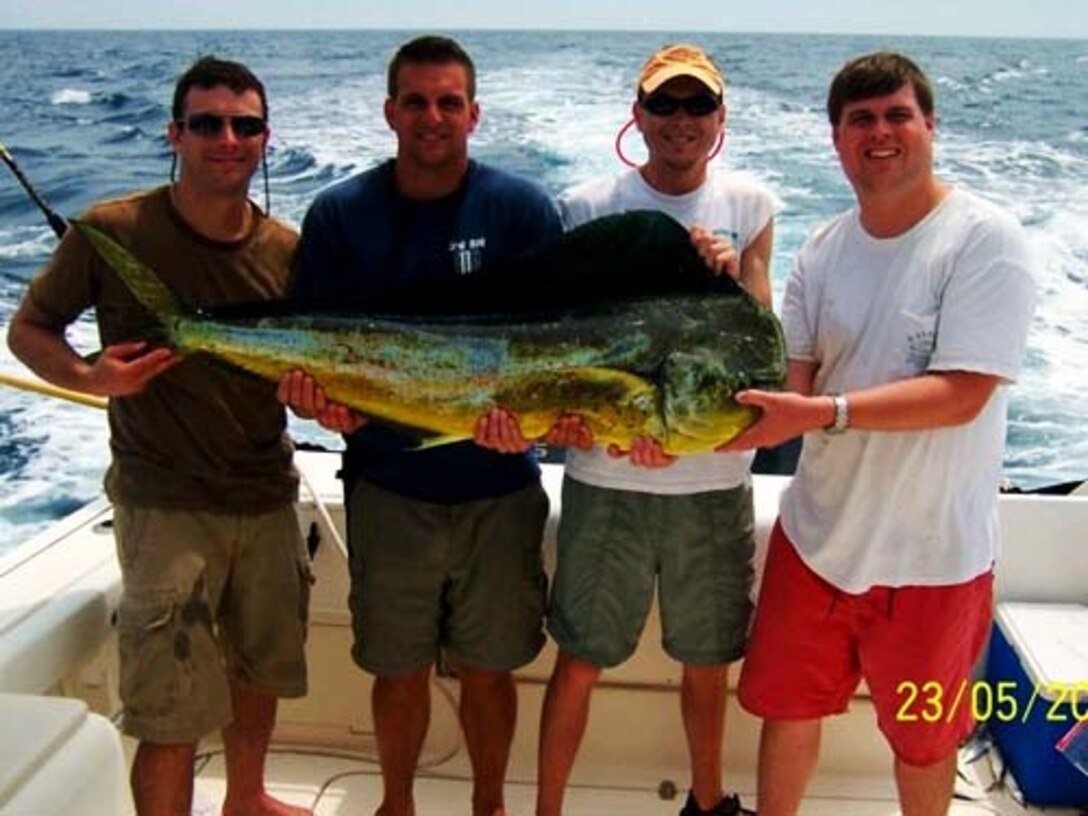Captain Bryan Lewis (center left) and his friend Jason (center right) with one of the trophies that were pulled in during an excursion written about in Capt. Lewis's winning essay "Yankee Luck." The essay finished first out of 23 submissions to The Charleston Angler's Photo and Essay Contest. (U.S. Air Force courtesy photo)