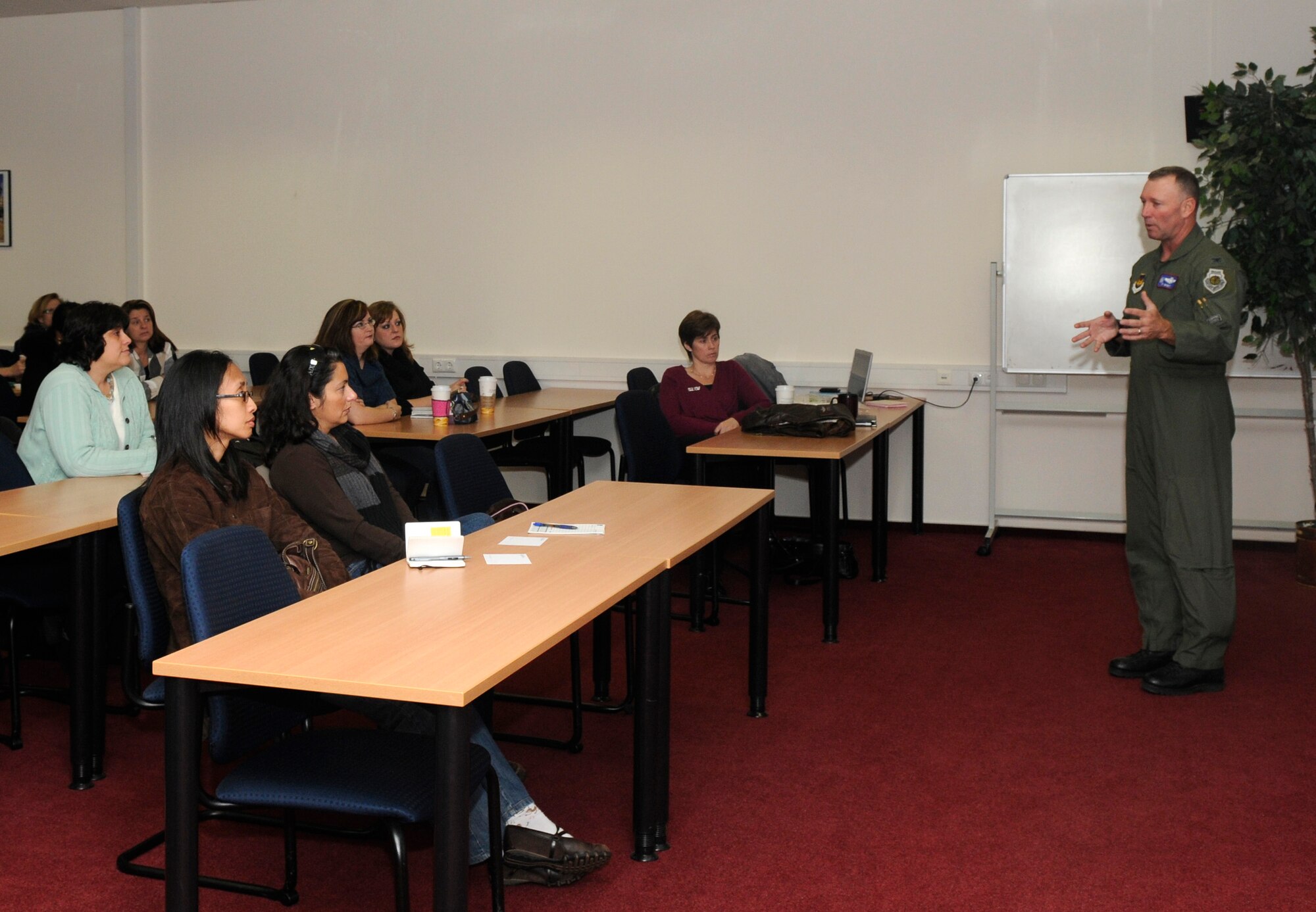 SPANGDAHLEM AIR BASE, Germany – Col. Tip Wight, 52nd Fighter Wing commander, gives a mission brief during the biannual spouses’ call Nov. 23 at the Wilkommen Center. The spouses’ call is an information forum for Saber spouses to share ideas and ask questions about the base. (U.S. Air Force photo/Airman 1st Class Staci Miller)