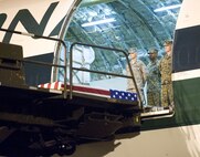 The remains of Lance Cpl. Nicholas J. Hand of Kansas City, MO., await transfer by a  U.S. Marine carry team at Dover Air Force Base, Del., November 24, 2009. Lance Cpl. Hand, 20, died Nov. 22 while supporting combat operations in Helmand province, Afghanistan.  He was assigned to 2nd Battalion, 2nd Marine Regiment, 2nd Marine Division, II Marine Expeditionary Force, Camp Lejeune, N.C. (USAF Photo by Brianne Zimny)