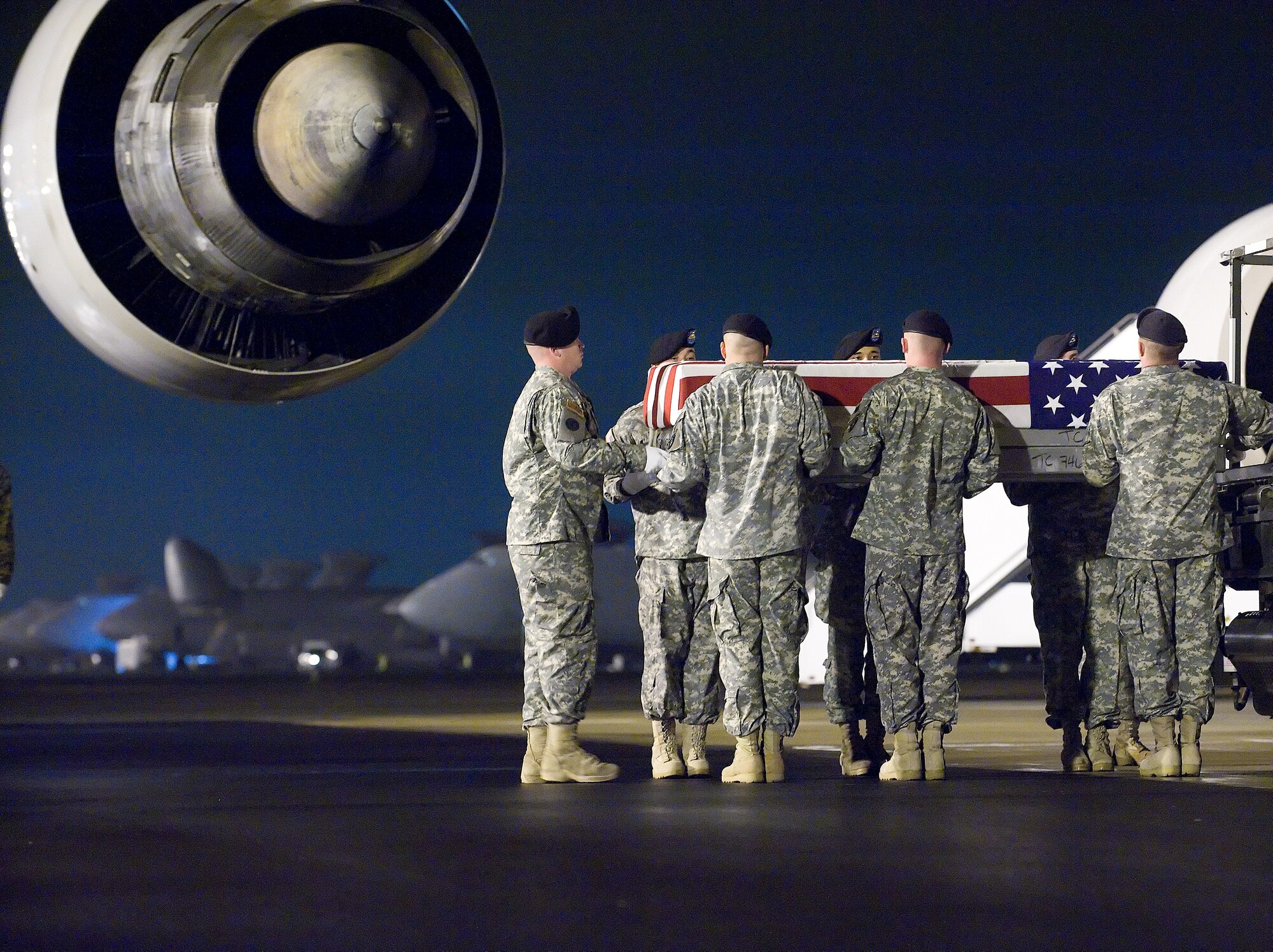 A U.S. Army carry team transfers the remains of Army Specialist Jason A. McLeod of Crystal Lake, Ill., at Dover Air Force Base, Del., Nov. 24, 2009. Specialist McLeod died Nov. 23rd, west of Pashmul, Afghanistan when his unit was attacked with mortar fire. He was assigned to the 704th Brigade Support Battalion, 4th Brigade Combat Team, 4th Infantry Division of Fort Carson, Colo. ( U.S. Air Force photo by Brianne Zimny)
