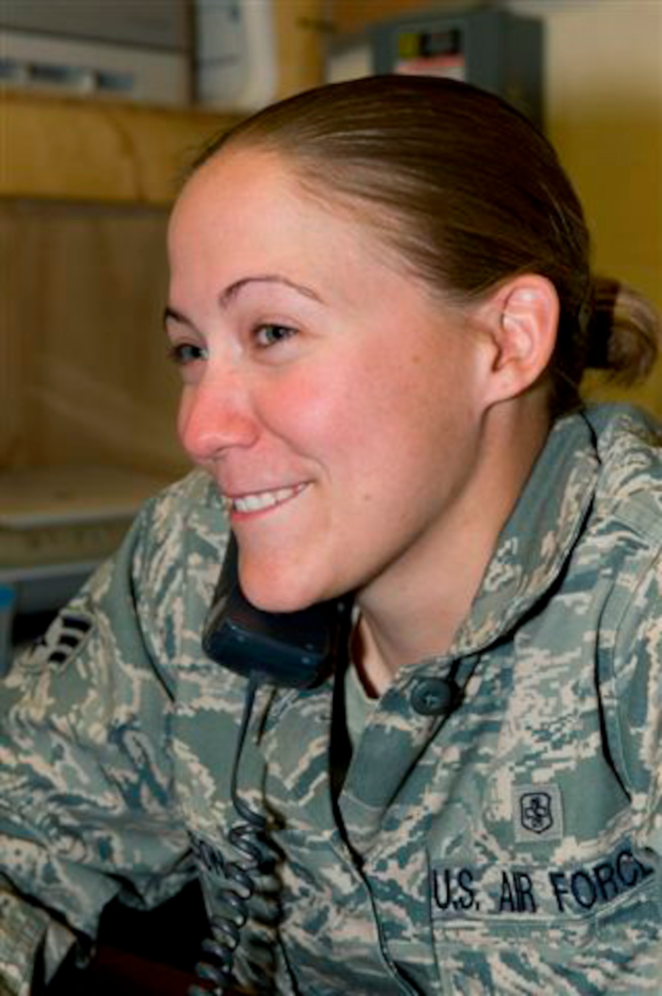 Senior Airman Ashley Jackson smiles as she listens to President Barack Obama's Thanksgiving message Nov. 26, 2009, at Forward Operating Base Morales-Frazier, Afghanistan. Airman Jackson, a medic with Provincial Reconstruction Team Kapisa, is originally from Lakeville, Minn. She is deployed from Eielson Air Force Base, Alaska. (Courtesy photo)
