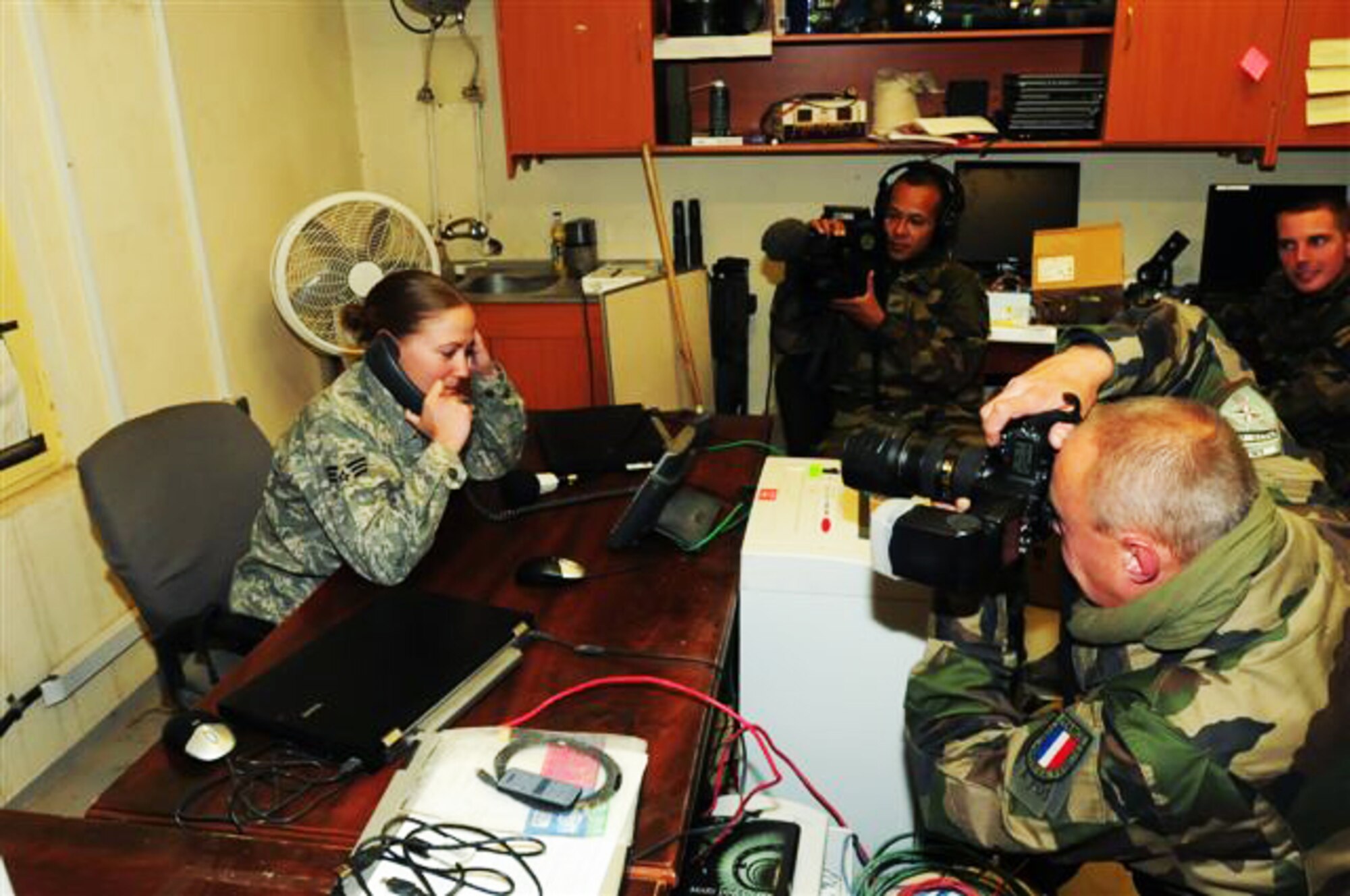 Senior Airman Ashley Jackson receives Thanksgiving greetings from President Barack Obama as French forces film the conversation Nov. 26, 2009, at Forward Operating Base Morales-Frazier, Afghanistan. Airman Jackson, a medic with Provincial Reconstruction Team Kapisa, is originally from Lakeville, Minn. She is deployed from Eielson Air Force Base, Alaska. (U.S. Air Force photo/Capt. Darrick Lee)
