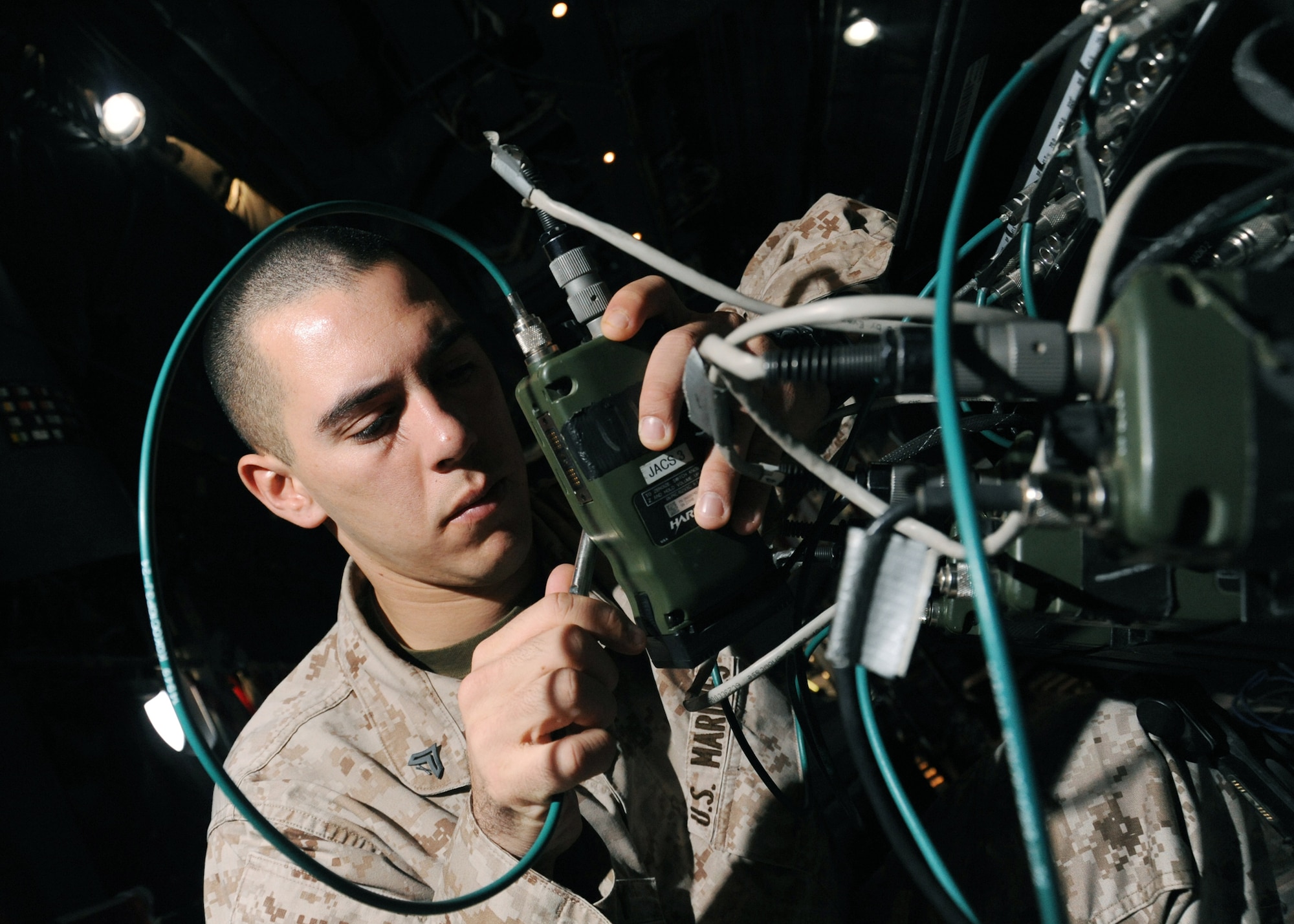 JOINT BASE BALAD, Iraq -- U.S. Marine Cpl. Joseph Colby, 777th Expeditionary Airlift Squadron air control electronics operator, checks the presets and frequencies of radios on a joint airborne battle staff detachment C-130 prior to a mission Nov. 24, 2009. The JABS is a joint operation focused on providing airborne communications support to ground forces. (U.S. Air Force photo/Senior Airman Christopher Hubenthal)