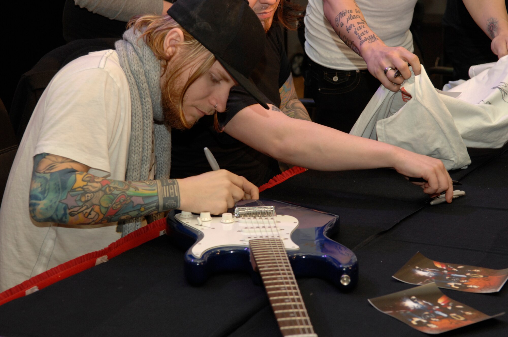 SPANGDAHLEM AIR BASE, Germany – Zach Myers, guitarist for Shinedown, autographs a guitar for a Saber Nov. 20 at the Brick House. Shinedown visited Spangdahlem during a European concert tour to sign autographs and take photographs with members of the Spangdahlem community. (U.S. Air Force photo/Senior Airman Kali L. Gradishar)