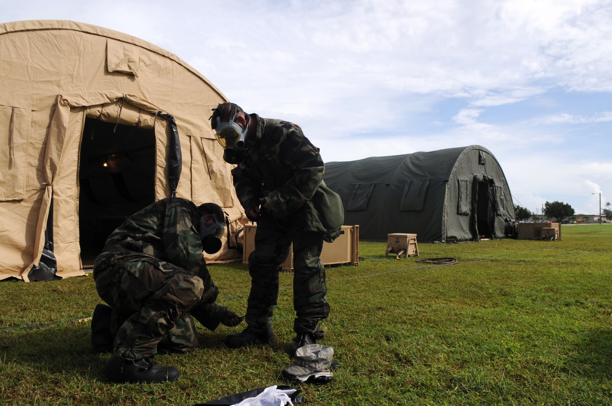 ANDERSEN AIR FORCE BASE, Guam - Airman 1st Class Michael Biggers completes a buddy check on Airman Timothy Hult as they practice putting on Mission Oriented Protective Posture 4 gear during an Operational Readiness Exercise here Oct. 23. The Airmen are assigned to the 36th Logistics Readiness Squadron as fuels apprentices. Senior leaders work closely with the 36th Wing inspector general office to schedule exercises in order to gauge mission readiness. (U.S. Air Force photo by Staff Sgt. Jennifer Redente)
