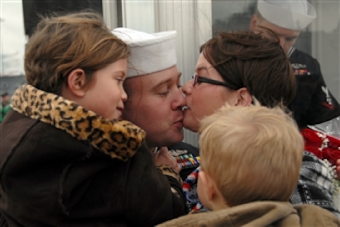U.S. Navy Petty Officer 1st Class William H. Kern receives the traditional first welcome-home kiss from his wife Nov. 25, 2009, after returning to Naval Station Norfolk, Va., following a six-month deployment aboard the attack submarine USS Montpelier.  