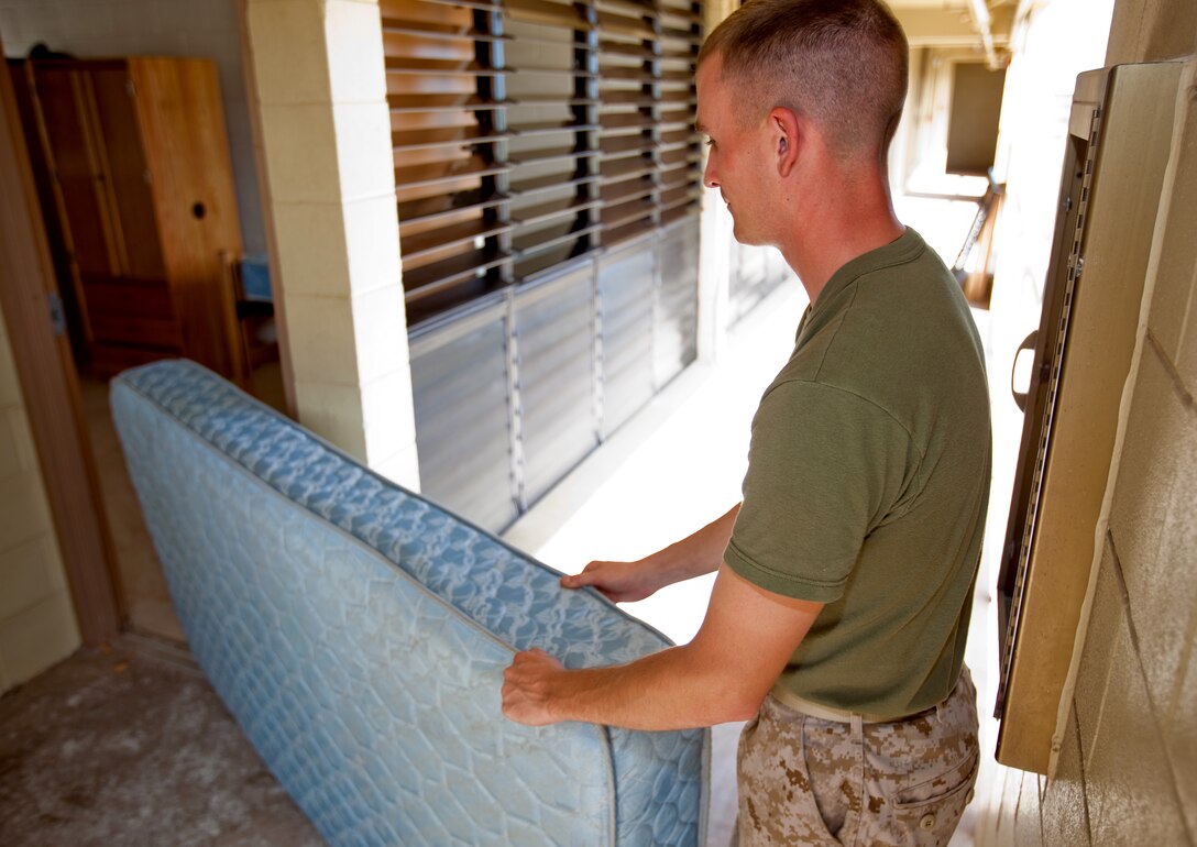 MCB HAWAII - A Marine drags a mattress out of a room at Barracks 5070 on Marine Corps Base Hawaii, Kaneohe Bay, Oct. 1. Due to Marine cooperation and relative "homelessness" endured for a few months, the barracks renovations are slated for completion Oct. 18, just in time for the dense population brought by upcoming returning units. (Official U.S. Marine Corps photo by Cpl. Achilles Tsantarliotis)(Released)