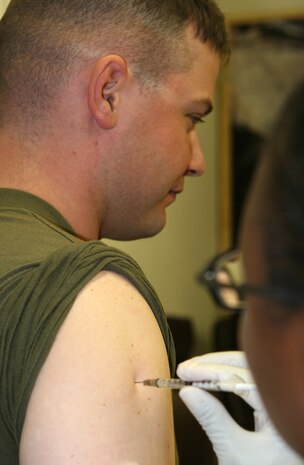 Sgt. Curtis L. Minnis, a supply clerk with Combat Logistics Regiment 27 (Forward), receives his influenza vaccination at a shot call aboard Camp Al Taqaddum, Iraq, Oct. 1, 2009.  Marines and sailors of CLR-27 (Fwd) are mandated to get their flu vaccination by Oct. 31.  (U.S. Marine Corps photograph by Lance Cpl. Melissa A. Latty)