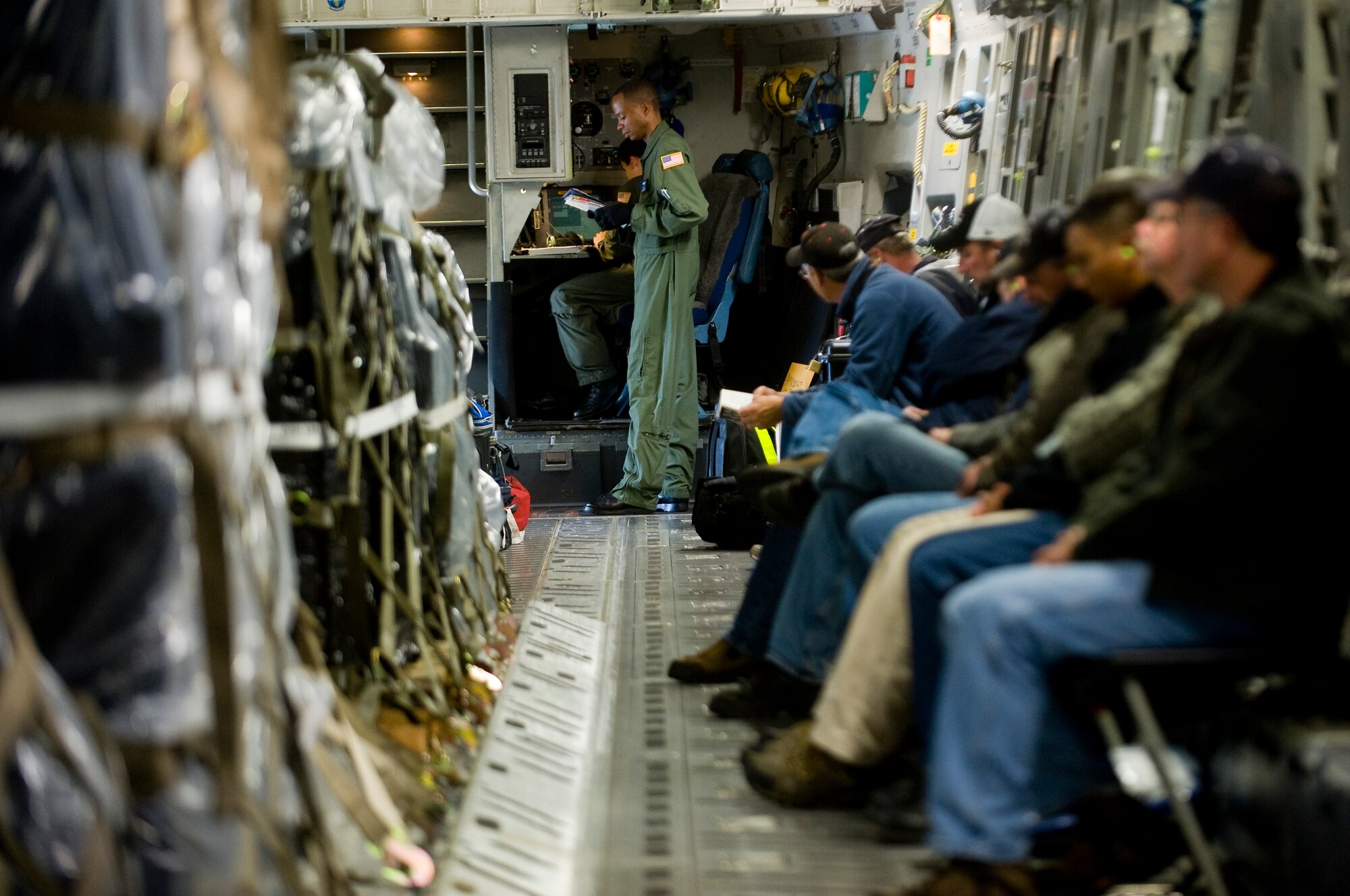 MCCHORD AIR FORCE BASE, Wash. – Tech. Sgt. Derrick Russell, 7th Airlift Squadron loadmaster, reviews a pre-flight checklist aboard a C-17 Globemaster III as FEMA representitives wait for take off Oct 1. In the wake of a 7.6 magnitude undersea earthquake that caused a devastating tsunami to strike American Samoa, McChord Airmen, on-alert to support any tasking associated with a mounting relief effort, deployed a U.S.-based FEMA team to the region at 2 p.m. (U.S. Air Force photo/Abner Guzman)(U.S. Air Force photo/Abner Guzman)
