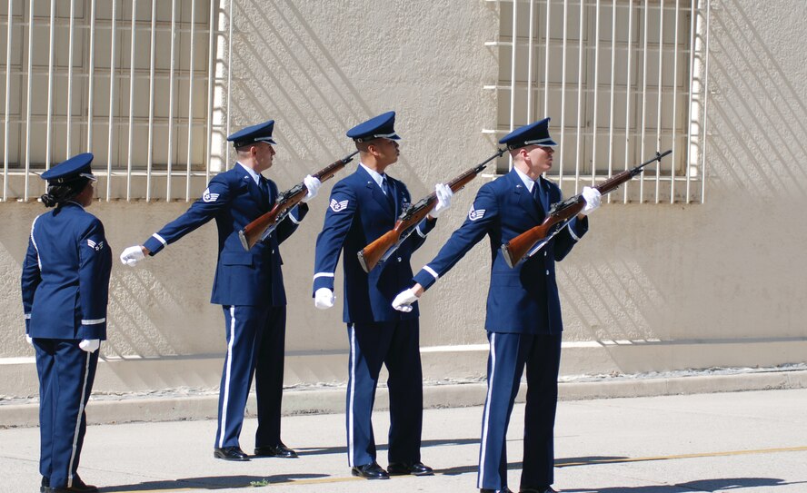 Formed outside the Cultural Resources Center, members of the Blue Eagles Total Force Honor Guard fire three volleys each during the POW/MIA Recognition Ceremony Sept. 18. They reassembled at the Cultural Resources Center that evening for their annual awards ceremony. (U.S. Air Force photo by Megan Just)