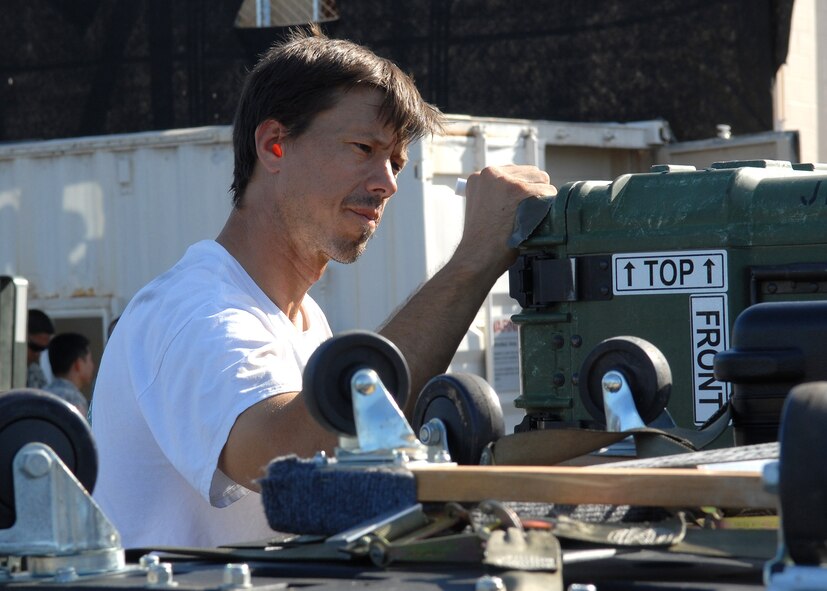 Matt Tramuto labels equipment for shipment, whcih was loaded onto one of two C-17 Globemaster IIIs, in support of a humanitarian mission Sept. 30 at Hickam Air Force Base, Hawaii.  Approximately 100 military personnel departed to provide aid for victims of a Tsunami that struck America Samoa tsunami Sept. 29.  (U.S. Air Force photo/Tech Sgt. Jerome S. Tayborn)