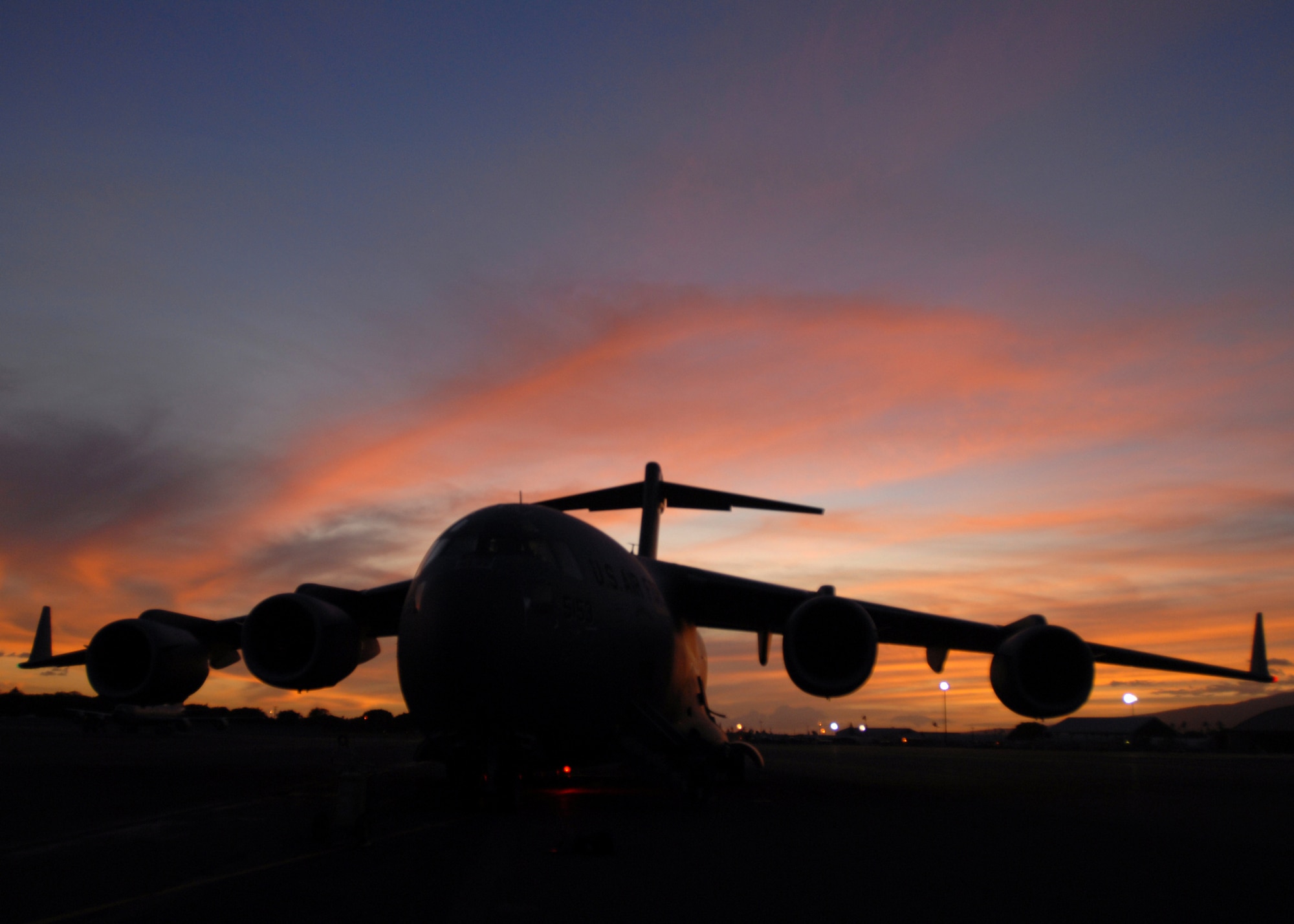 HICKAM AIR FORCE BASE, Hawaii -- A C-17 Globemaster III sits at Hickam as crews prepare to take off to deliver humanitarian supplies to the tsunami devastated Samoa region in the South Pacific. A multi-agency contingent from Hawaii, including Active Duty Airmen at Hickam, the Hawaii National Guard and the Hawaii Air National Guard, took off bound for American Samoa with relief supplies and equipment to assist in the region. Reports indicate the islands have suffered greatly, villages are wiped out and more than a thousand residents and visitors are displaced. An undersea earthquake churned up tsunamis Sept. 30 that left more than 140 people dead in the Samoa region. More than 90 Airmen and Soldiers deployed from Hawaii for the humanitarian mission. (U.S. Air Force photo/Staff Sgt. Mike Meares)