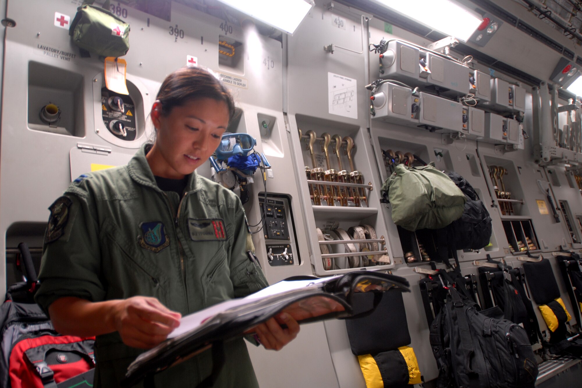 HICKAM AIR FORCE BASE, Hawaii -- Capt. B.J. Itoman, a Hawaii Air National Guard C-17 pilot, goes over paperwork as humanitarian aid supplies from the Federal Emergency Management Agency is loaded by Hawaii Air National Guard, Hawaii National Guard and Hickam Active Duty Airmen into a C-17 Globemaster III bound for American Samoa to assist in the relief efforts underway Sept 30. The efforts are in the wake of tsunamis triggered by an undersea earthquake Sept. 29 that has left more than 140 people dead in the South Pacific region. More than 90 Airmen and Soldiers deployed from Hawaii for the humanitarian mission. (U.S. Air Force photo/Staff Sgt. Mike Meares)
(U.S. Air Force photo/Staff Sgt. Mike Meares)