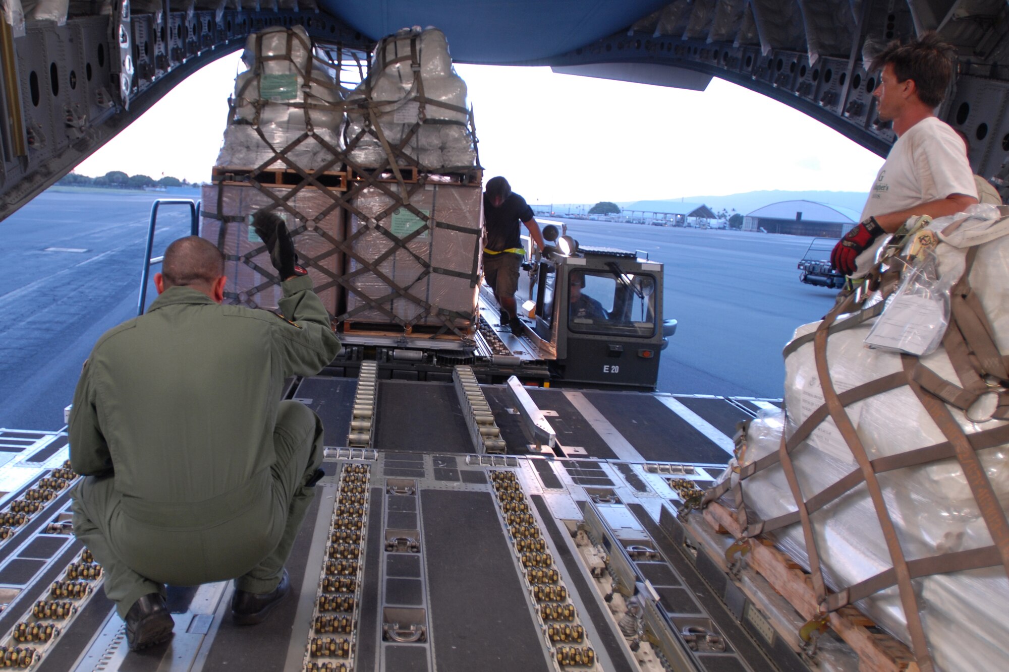 HICKAM AIR FORCE BASE, Hawaii -- Tech. Sgt. Kimo McKee, Hawaii Air National Guard loadmaster, directs the loading of humanitarian aid supplies from the Federal Emergency Management Agency by Hawaii Air National Guard, Hawaii National Guard and Hickam Active Duty Airmen into a C-17 Globemaster III bound for American Samoa to assist in the relief efforts underway Sept 30. The efforts are in the wake of tsunamis triggered by an undersea earthquake Sept. 29 that has left more than 140 people dead in the South Pacific region. More than 90 Airmen and Soldiers deployed from Hawaii for the humanitarian mission. (U.S. Air Force photo/Staff Sgt. Mike Meares)
(U.S. Air Force photo/Staff Sgt. Mike Meares)