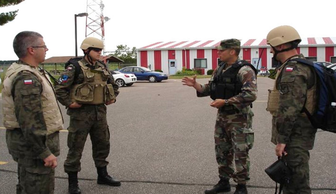 VOLK FIELD, Wis.  A soldier from the Illinois National Guard briefs Polish soldiers on the Joint Terminal Attack Controller evaluation process. As part of the State Partnership Program in the U.S. European Command, officers from the Polish joint terminal attack controller school observed and participated in Operation Global Patriot July 7-18, 2009. Along with conducting actual F-16 and A-10 close air support controls during the operation the officers also observed day-to-day operation of an establish U.S. Air Force Tactical Air Control Party squadron. (Department of Defense photo)