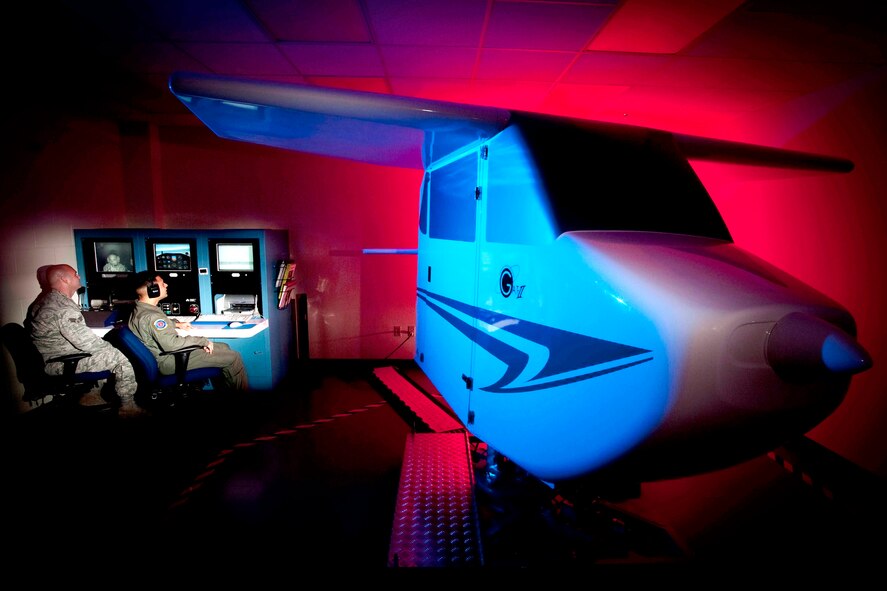 Senior Airman Jason Boyd (left) and Staff Sgt. Vikas Kumar monitor a trainee during night instrument training in the General Aviation Trainer II used to familiarize aviators with the effects of spatial disorientation and the importance of trusting their instruments and not how they feel Sept. 30, 2009, at Randolph Air Force Base, Texas. Airman Boyd and Sergeant Kumar are aerospace physiology technicians with the 12th Medical Group. (U.S. Air Force photo/Steve Thurow)