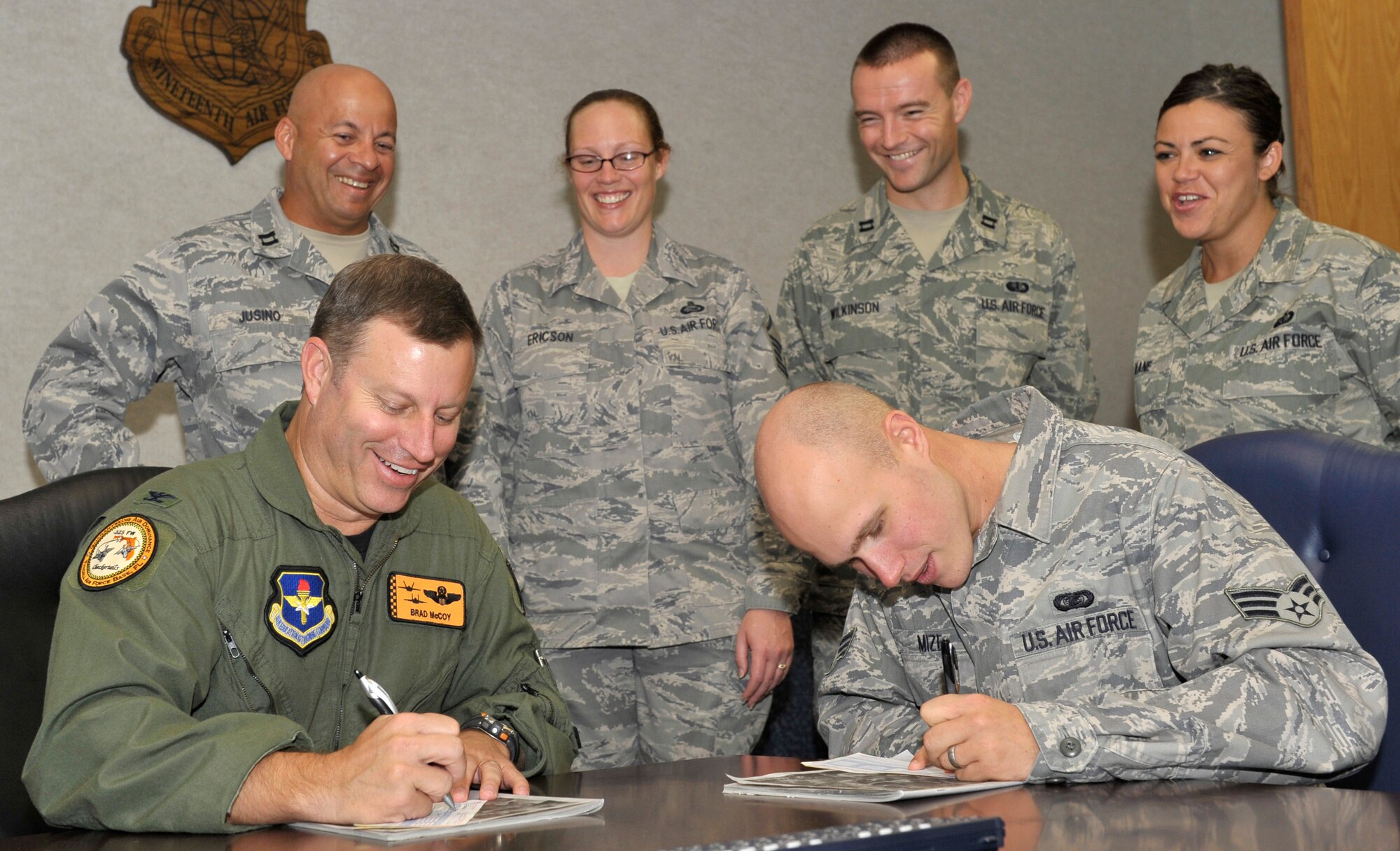 Col. Bradley McCoy, 325th Fighter Wing vice commander, and Senior Airman Matthew Mize, 325th FW knowledge operations manager, kick-off the Tyndall Air Force Base, Fla., Combined Federal Campaign by signing their annual pledge cards Oct. 1.  The 2009 Combined Federal Campaign, a fundraising effort for more than 1,200 charitable organizations, begins now and will run through Nov. 15. (U.S. Air Force photo/Jonathan Gibson) 