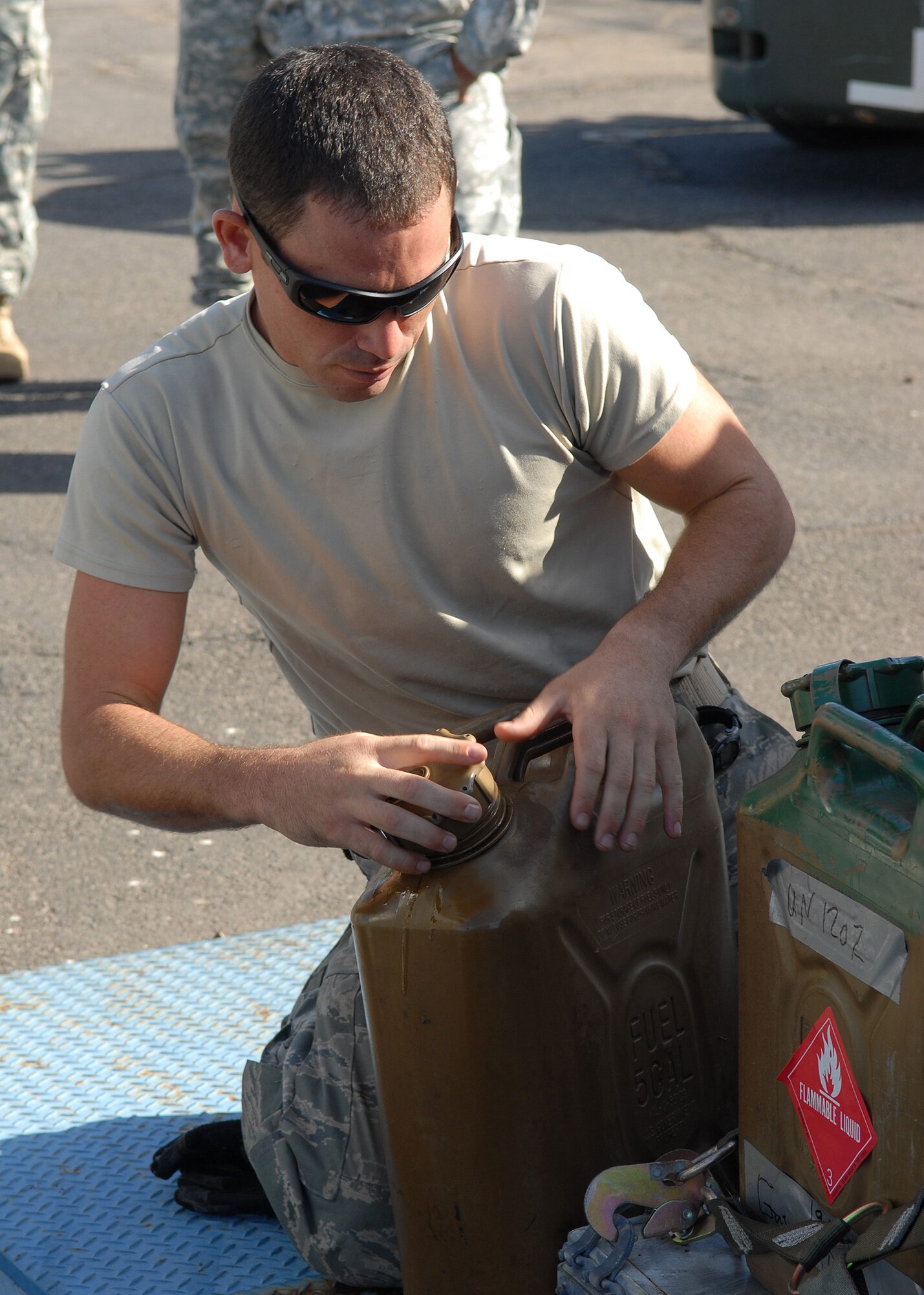 Staff Sergeant Nathan Angel verifies and labels one of many gasoline cans, before palletizing and shipping them out Sept. 30 at Hickam Air Force Base, Hawaii, in support of a humanitarian mission to American Samoa. Members of Hickam, along with members of the Hawaii National Guard and Air Guard, departed Hickam to provide aid to the island nation, which was affected by an earthquake and a Tsunami Sept. 29. Sergeant Angel is with the 15th Logistics Readiness Squadron. (U.S. Air Force photo/Tech. Sgt. Jerome S. Tayborn)