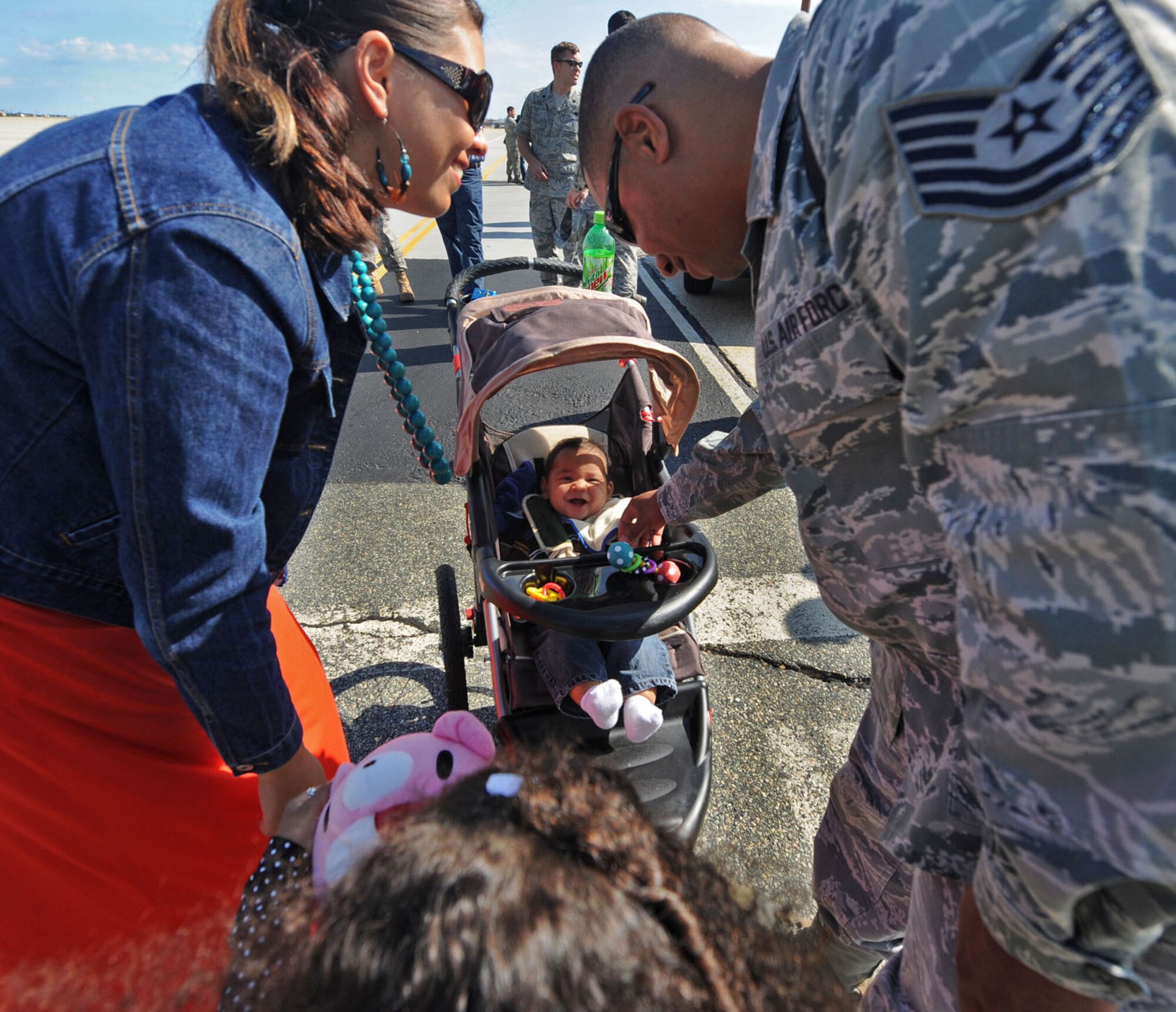 LANGLEY AIR FORCE BASE, Va. --  Tech. Sgt. Claude O’Hara, 1st Communications Squadron network core services system administrator, greets his wife, Rhonda, and 6-month-old son, Jonathan, during his homecoming here Oct. 1. Sergeant O'Hara returned from a 120-day deployment to Kadena Air Base, Japan, in support of the Pacific Theater Security Package and to ensure stability in the region.  (U.S. Air Force photo/Airman Rebecca Montez)
