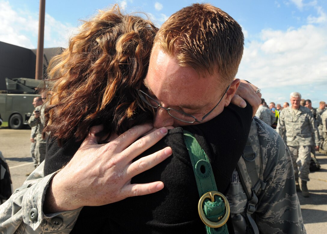 LANGLEY AIR FORCE BASE, Va. --  Senior Airman Christopher Gilbert, 94th Fighter Squadron avionics specialist, holds his fiancé Kristen Delizzio during his homecoming here Oct 1. Airman Gilbert returned from a 120-day deployment to Kadena Air Base, Japan, in support of the Pacific Theater Security Package and to ensure stability in the region.  (U.S. Air Force photo/Airman Rebecca Montez)