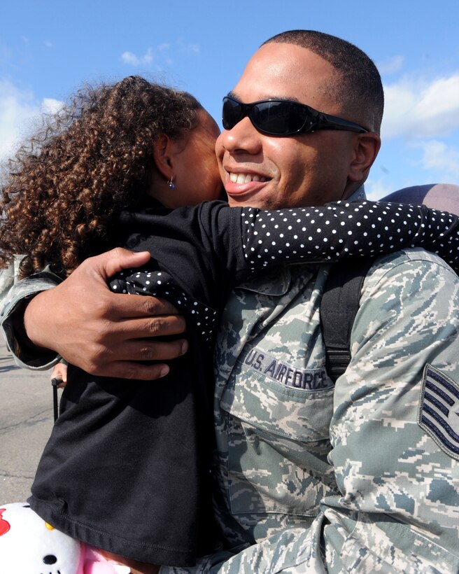 LANGLEY AIR FORCE BASE, Va. --  Tech. Sgt. Claude O’Hara, 1st Communications Squadron network core services system administrator, hugs his 4-year-old daughter, Alyxandria, upon his homecoming here Oct. 1. Sergeant O'Hara returned from a 120-day deployment to Kadena Air Base, Japan, in support of the Pacific Theater Security Package and to ensure stability in the region. (U.S. Air Force photo/Airman Rebecca Montez)