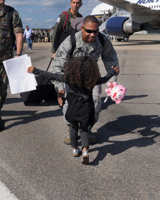 LANGLEY AIR FORCE BASE, Va. --  Tech. Sgt. Claude O’Hara, 1st Communications Squadron Network core services system administrator, greets his 4-year-old daughter, Alyxandria, during his homecoming here Oct. 1. Sergeant O'Hara returned from a 120-day deployment to Kadena Air Base, Japan, in support of the Pacific Theater Security Package and to ensure stability in the region.  (U.S. Air Force photo/Airman Rebecca Montez)