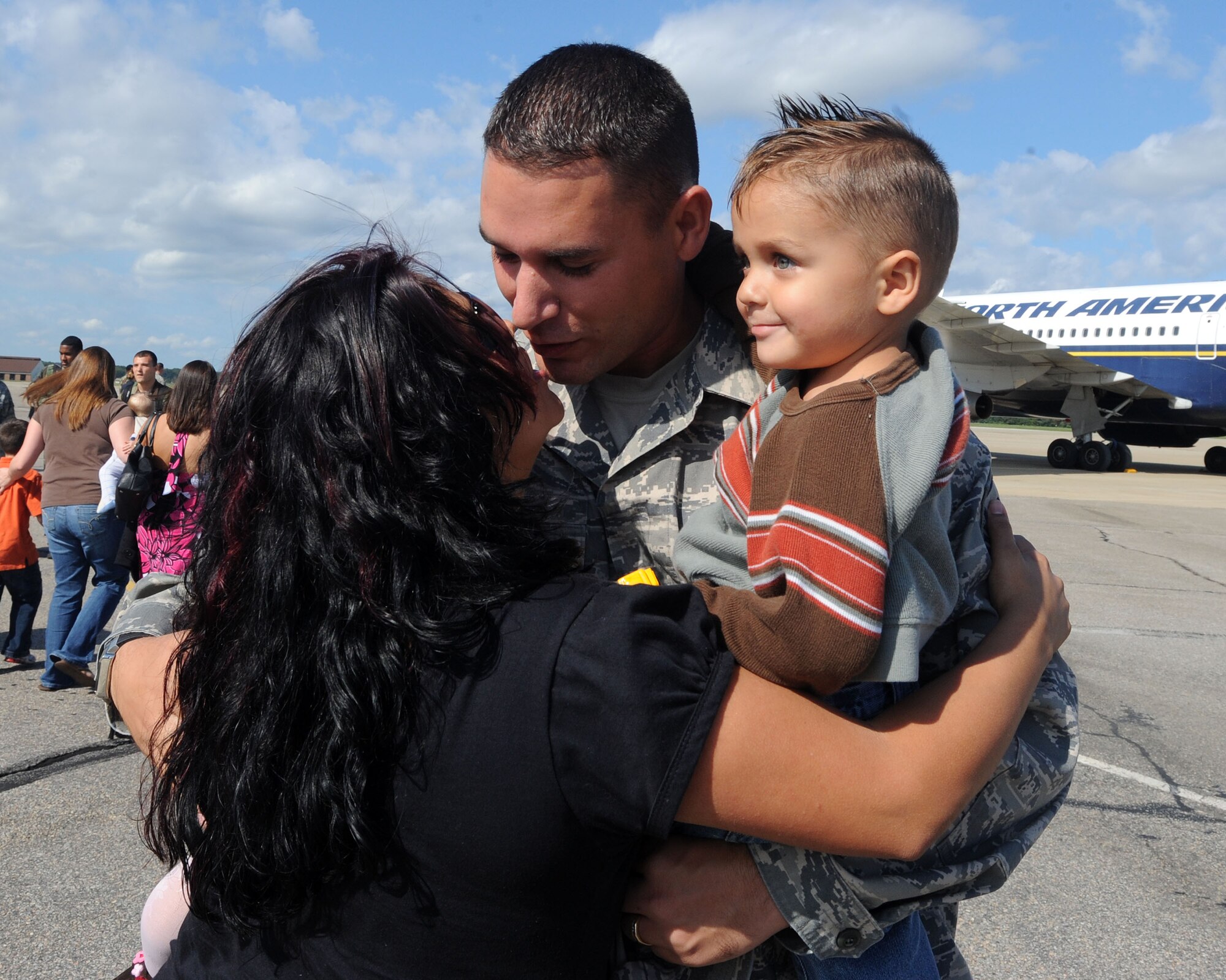 LANGLEY AIR FORCE BASE, Va. --  Master Sgt. Manuel Baez, 1st Component Maintenance Squadron first sergeant, greets his wife, Jordan, and 2-year-old son, Taylor, during his homecoming Oct. 1. Sergeant Baez returned from a 120-day deployment to Kadena Air Base, Japan, in support of the Pacific Theater Security Package and to ensure stability in the region. (U.S. Air Force photo/Airman Rebecca Montez)