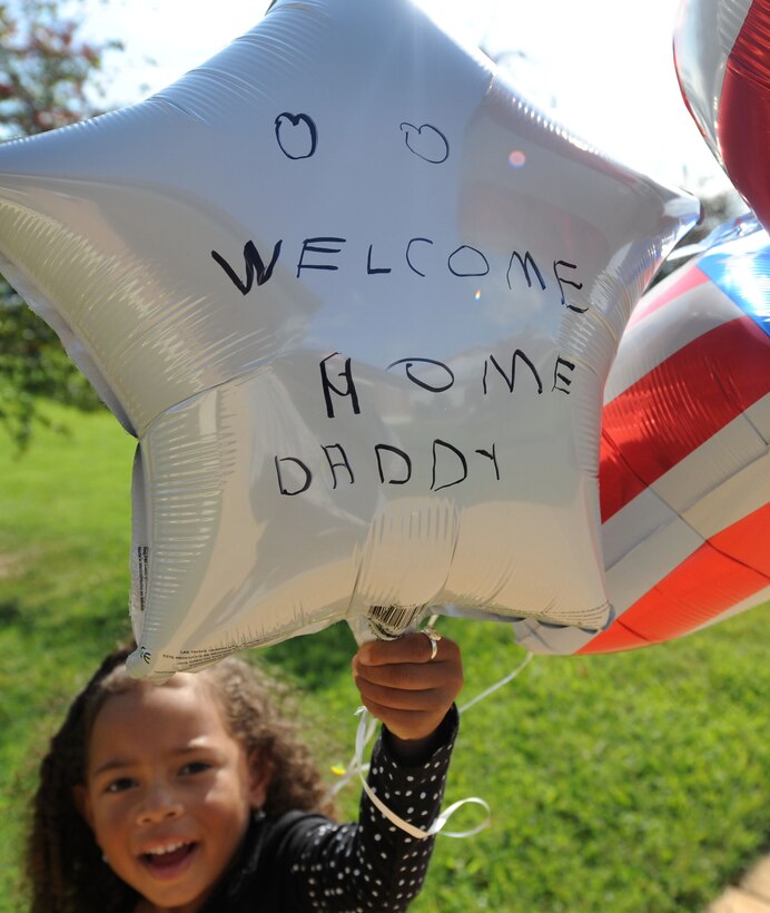 LANGLEY AIR FORCE BASE, Va. --  Alyxandria O'Hara, 4, daughter of Tech. Sgt. Claude O'Hara, 1st Communications Squadron, shows off a balloon she decorated celebrating the homecoming of her father, Oct. 1. Sergeant O'Hara is returning from a 120-day deployment to Kadena Air Base, Japan. (U.S. Air Force photo/Airman Rebecca Montez)