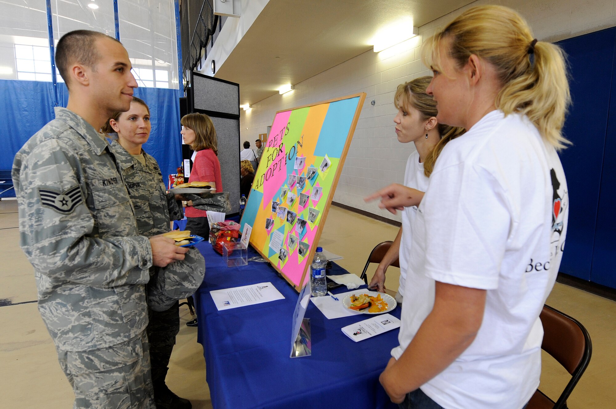 HOLLOMAN AIR FORCE BASE, N.M. -- Staff Sgts. Kyle Kinder and Kimberly Cooper, contract administrators with the 49th Contracting Squadron, speak with representatives of the Veterinary Medical Clinic, Inc. about their charity campaign at the Domenici Fitness and Sports Center here, Sept. 30, during the Combined Federal Campaign kickoff. The CFC gives individuals the opportunity to support a charity of their choosing. (U.S. Air Force photo by Senior Airman Tiffany Trojca)