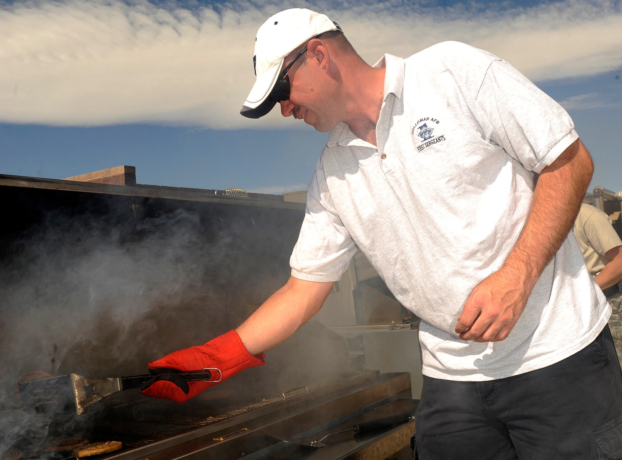 HOLLOMAN AIR FORCE BASE, N.M. -- Master Sgt. Robert Stamper, 49th Security Forces Squadron first sergeant, grills burgers during the first day of the Combined Federal Campaign at the Domenici Fitness and Sports Center here, Sept. 30. The CFC gives individuals the opportunity to support a charity of their choosing. (U.S. Air Force photo by Senior Airman Tiffany Trojca)
