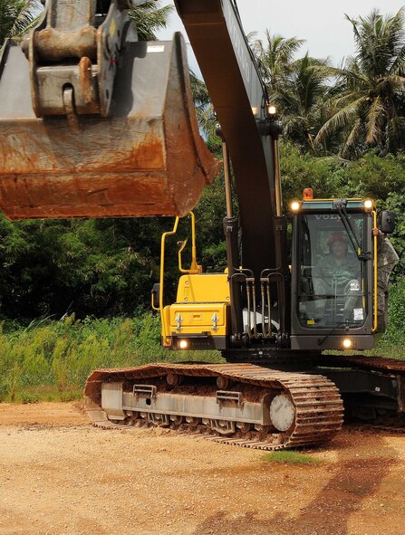 ANDERSEN AIR FORCE BASE, Guam - Pacific Air Forces Commander General Gary North takes lessons in operating the excavator from Airman 1st Class Isaiah Jones, 554th RED HORSE Squadron dirtboy. (U.S. Air Force photo by Senior Airman Nichelle Anderson)