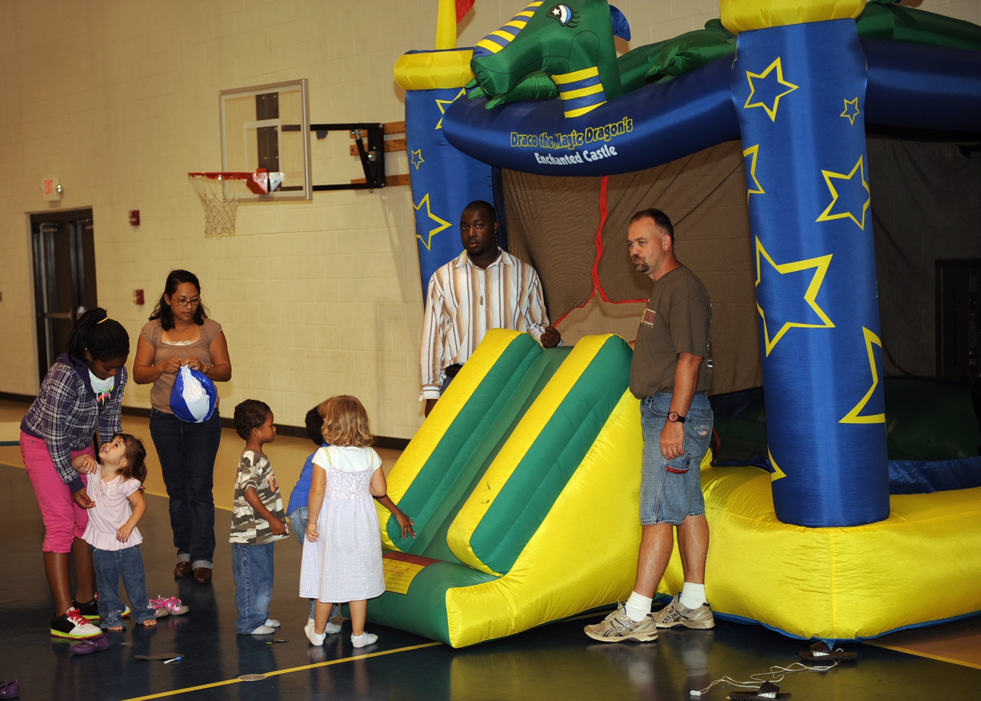 Base youth wait their turn to enter the bouncy castle at the Yellow Ribbon event/Worldwide Day of Play held at the Youth Center on Seymour Johnson Air Force Base, N.C., Sept. 25, 2009. The event was held to give parents an opportunity to socialize with other parents and give children a chance to play together. (U.S. Air Force/Senior Airman Ciara Wymbs)