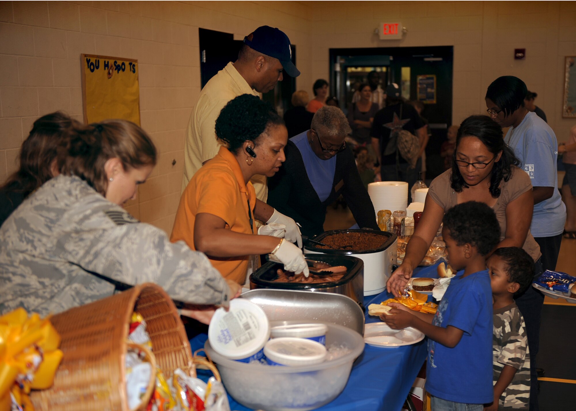 Members from the Airman and Family Readiness Center serve food during the Yellow Ribbon/Worldwide Day of Play event at the Youth Center on Seymour Johnson Air Force Base, N.C., Sept. 25, 2009. The AFRC hosted the quarterly event, the next is scheduled for this winter. (U.S. Air Force/Senior Airman Ciara Wymbs)