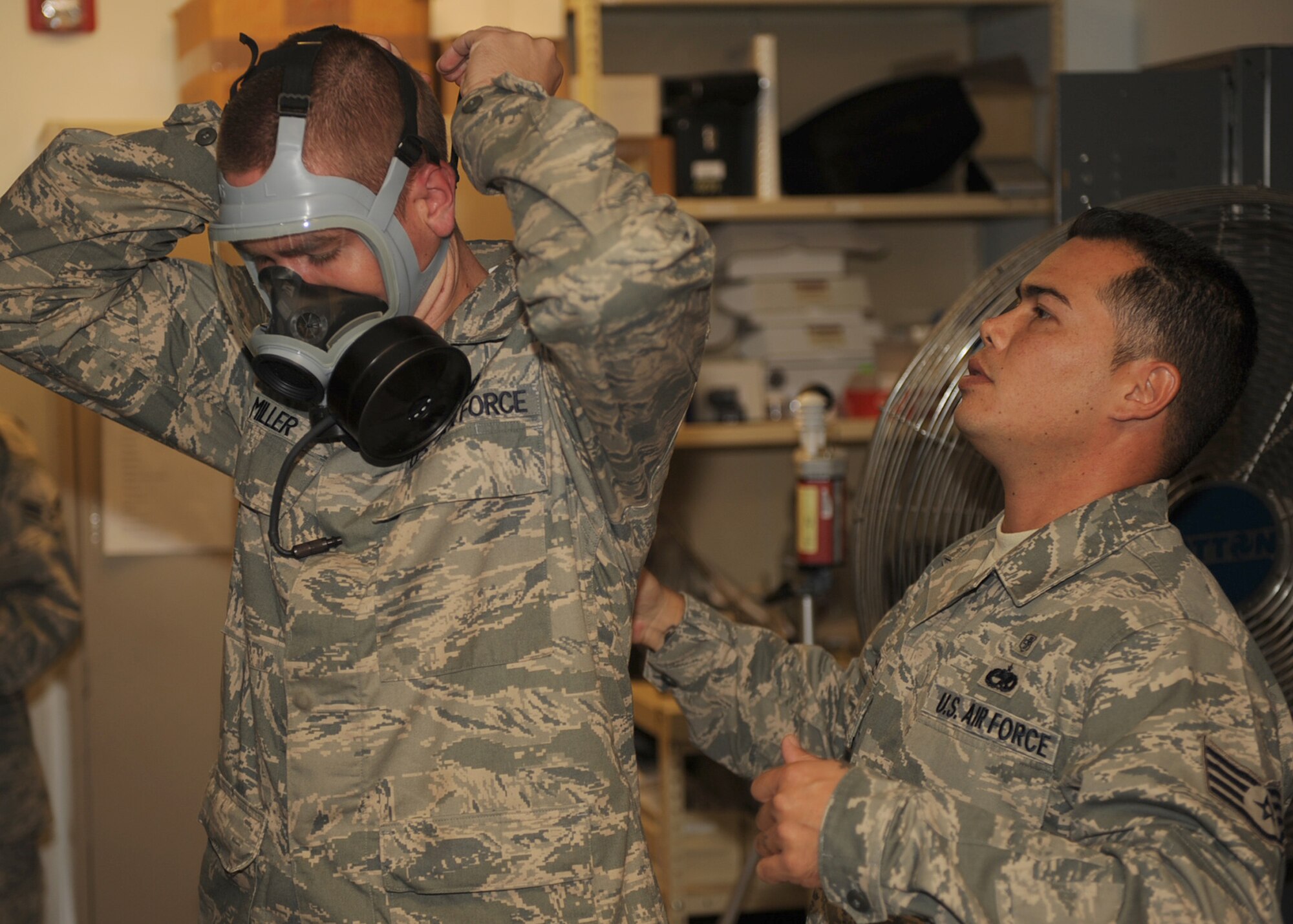 Staff Sgt. Brian Moses, 4th Aeromedical Dental Squadron bioenvironmental technician, performs a gas mask fit test on Airman 1st Class Christopher Miller, 4th Logistics Readiness Squadron vehicle operator, at Seymour Johnson Air Force Base, N.C., Sept. 24, 2009. The test ensures proper mask fitting so no harmful agents can enter the mask and harm personnel. (U.S. Air Force photo/Senior Airman Ciara Wymbs) 	 