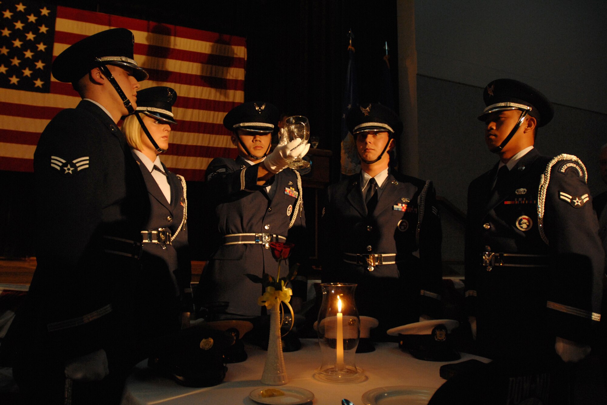 Honor Guard Airmen present an empty glass on a POW/MIA table during an Air Force ball at McConnell Air Force Base, Kan., Sept. 25, 2009. In addition to commemorating the Air Force’s creation on Sept. 18, 1947, the ball’s theme ‘Year of the KC-135” celebrated the 22nd Air Refueling wing’s mission. (U.S. Air Force photo/Staff Sgt. Jamie Train)