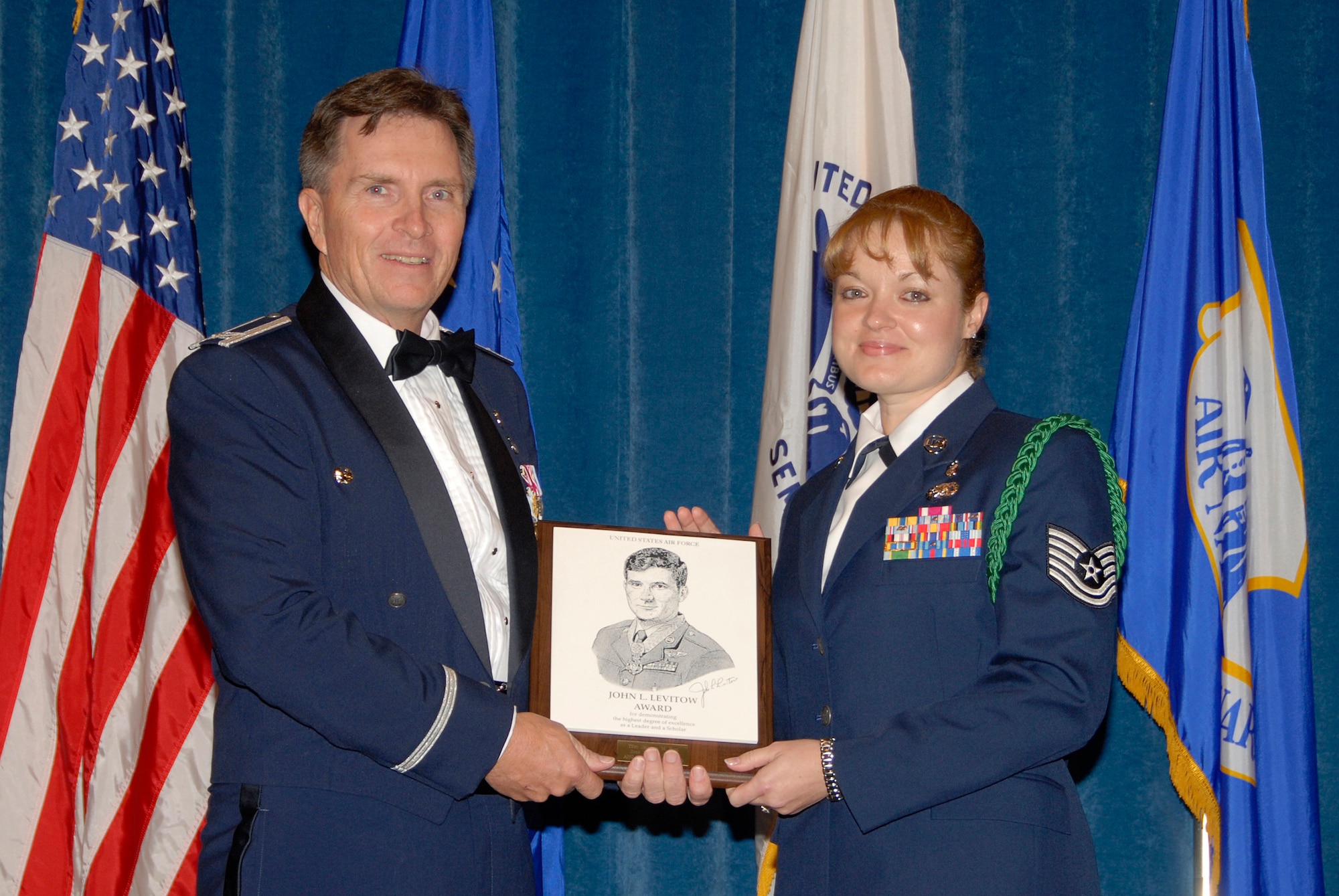 McGHEE TYSON AIR NATIONAL GUARD BASE, Tenn. -- Tech. Sgt. Jennifer M. Pahl, the NCOIC, military health flight of the 49th Medical Operations Squadron at Holloman AFB, N.M., receives the John L. Levitow Honor Award for NCO Academy Class 09-6 at The I.G. Brown Air National Guard Training and Education Center here from Col. Richard B. Howard.  The John L. Levitow Award is the highest honor awarded a graduate of any Air Force enlisted professional military education course.  (U.S. Air Force photo by Master Sgt. Kurt Skoglund)