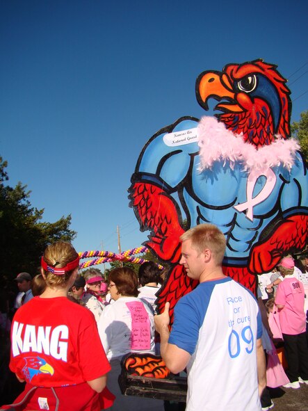 (Left) Capt Alyson Stockton and Capt Dana Stockton, carry the team mascot through the starting line of the 1-mile walk of the Susan G.Komen Race for the Cure on Septebmer 26th.  The team was the largest out of
the 245 assembled at the local race.
