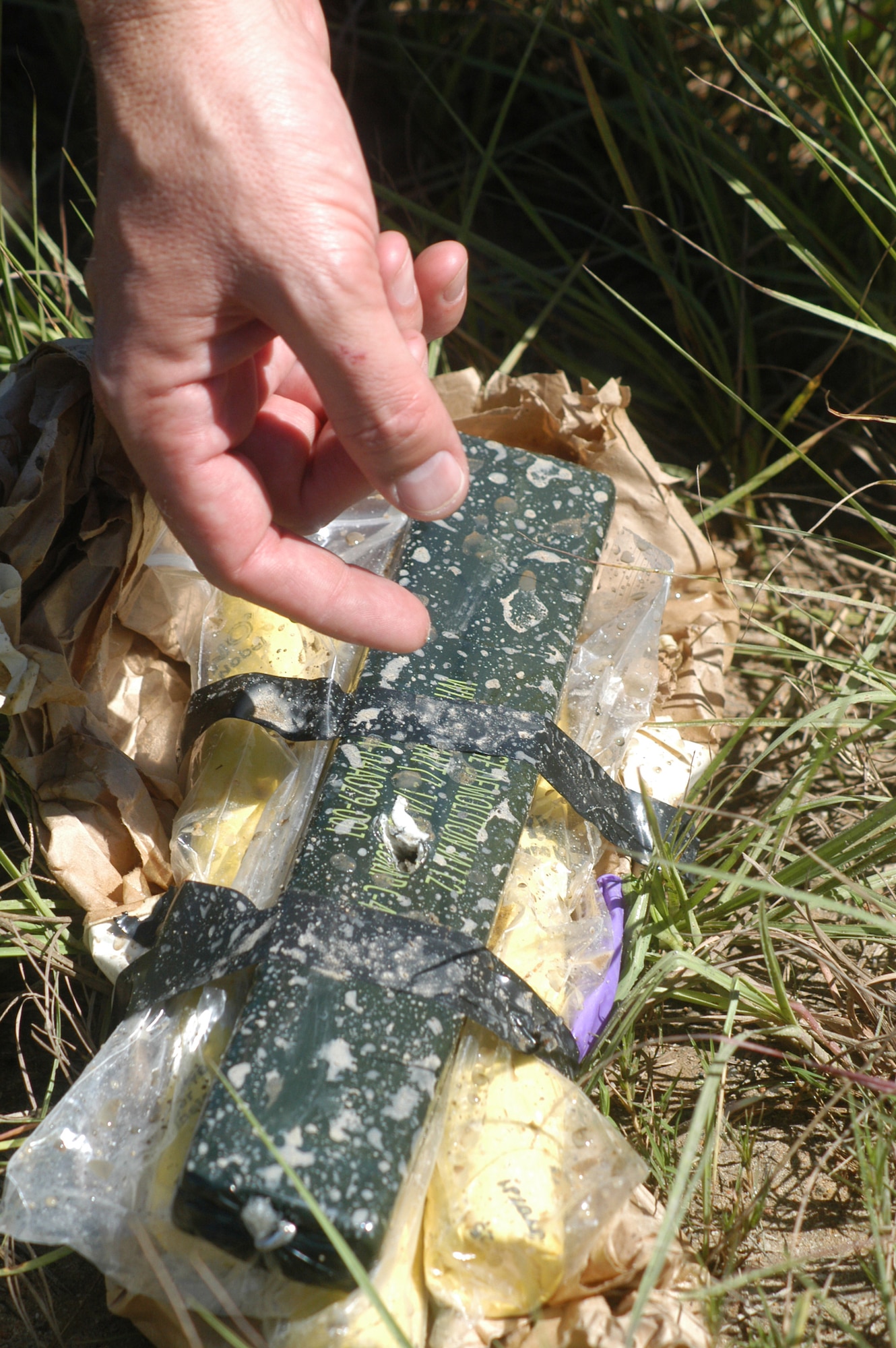 Three sticks of dynamite are attached to C-4 to be destroyed Sept. 30 in the EOD blasting area. U. S. Air Force photo by Sue Sapp