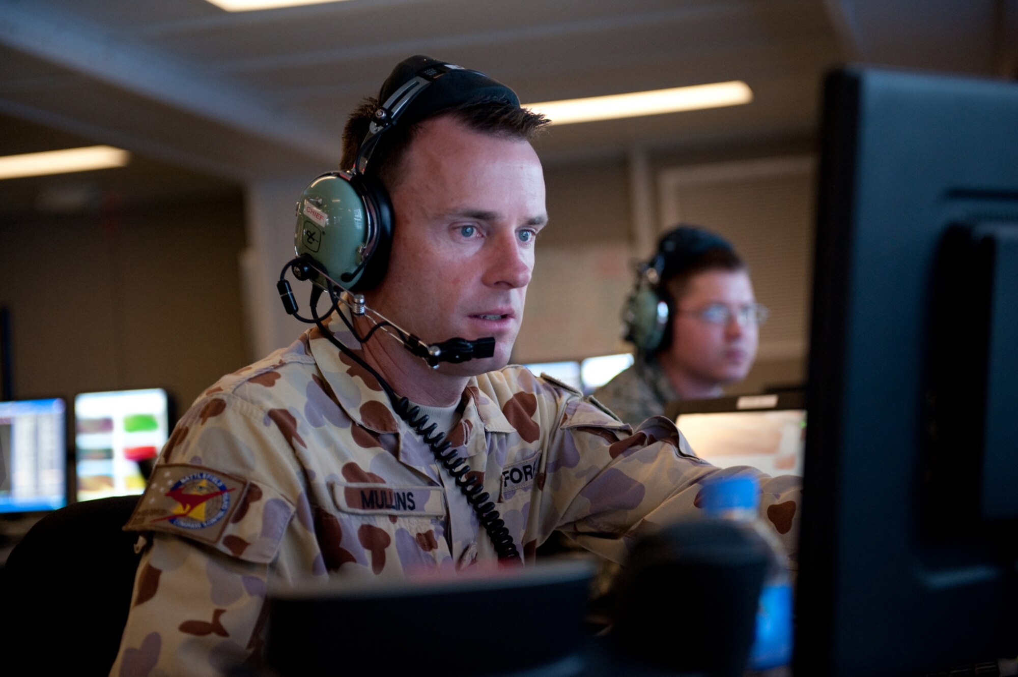 Royal Australian Air Force Warrant Officer Jamie Mullins, 71st Expeditionary Air Control Squadron air surveillance technician, monitors and identifies aircraft within his assigned airspace, Sept. 30, in Southwest Asia. Warrant Officer Mullins helps provide round-the-clock air defense and air battle execution of Southwest Asia in support of Operations Iraqi and Enduring Freedom, and Combined Joint Task Force-Horn of Africa. (U.S. Air Force Photo/Staff Sgt. Robert Barney/Released) 