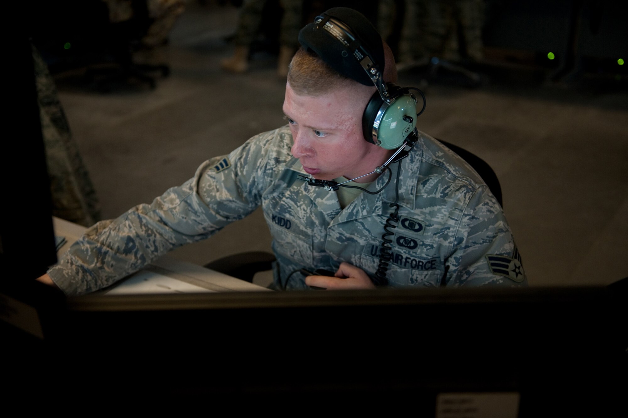 U.S. Air Force Senior Airman Chad Kidd, 71st Expeditionary Air Control Squadron weapons director, directs and controls support and combat aircraft into target areas, Sept. 30, in Southwest Asia. The 71 EACS provides round-the-clock air defense and air battle execution of Southwest Asia. Airman Kidd is deployed from Mountain Home Air Force Base, Idaho, in support of Operations Iraqi and Enduring Freedom, and Combined Joint Task Force-Horn of Africa. (U.S. Air Force Photo/Staff Sgt. Robert Barney/ Released)