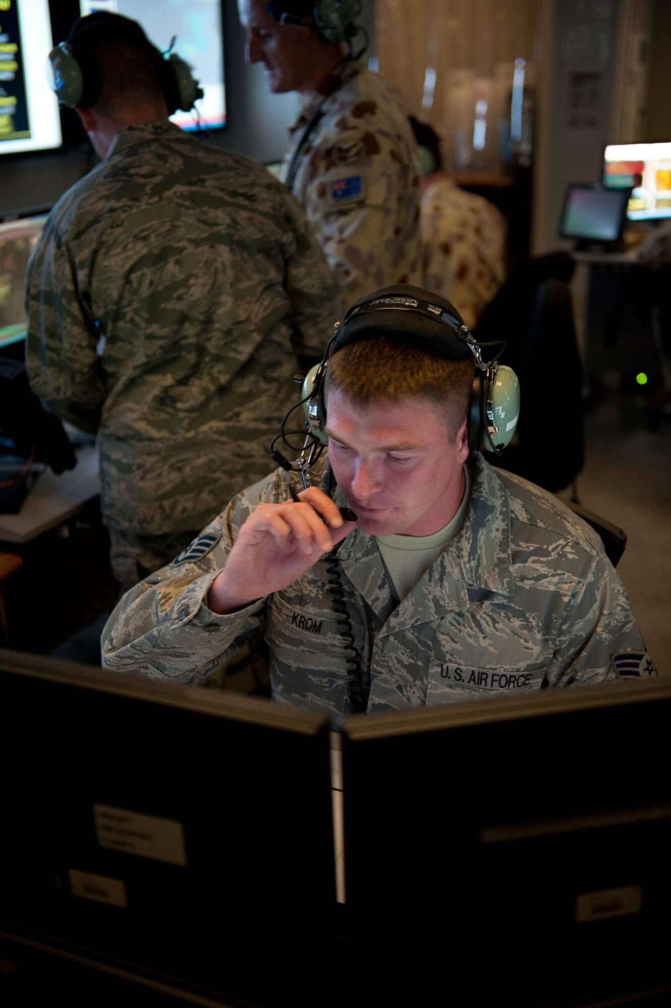 U.S. Air Force Staff Sgt. Scott Krom, 71st Expeditionary Air Control Squadron weapons director, directs and controls support and combat aircraft into target areas, Sept. 30, in Southwest Asia. The 71 EACS provides round-the-clock air defense and air battle execution of Southwest Asia. Sergeant Krom is deployed from Mountain Home Air Force Base, Idaho, in support of Operations Iraqi and Enduring Freedom, and Combined Joint Task Force-Horn of Africa. (U.S. Air Force Photo/Staff Sgt. Robert Barney/ Released)