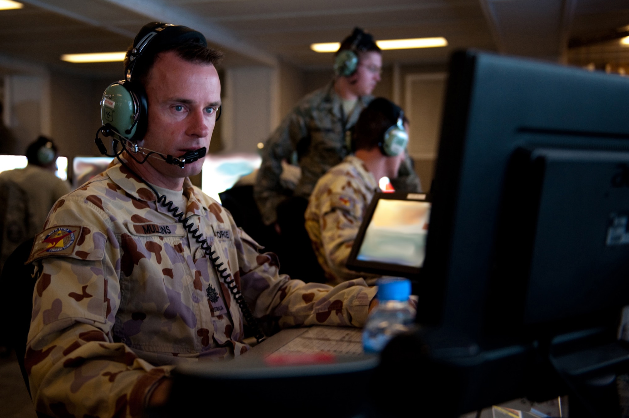 Royal Australian Air Force Warrant Officer Jamie Mullins, 71st Expeditionary Air Control Squadron air surveillance technician, monitors and identifies aircraft within his assigned airspace, Sept. 30, in Southwest Asia. Warrant Officer Mullins helps provide round-the-clock air defense and air battle execution of Southwest Asia in support of Operations Iraqi and Enduring Freedom, and Combined Joint Task Force-Horn of Africa. (U.S. Air Force Photo/Staff Sgt. Robert Barney/Released) 